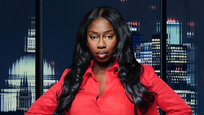 A woman (Vanessa Tetteh-Squire) in a red suit poses outside a city landscape 