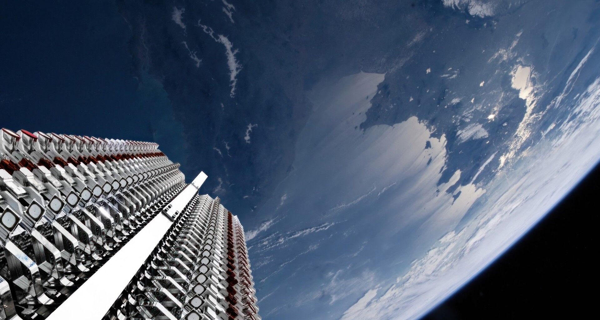 rows of metallic objects are folded up in a rack high above earth