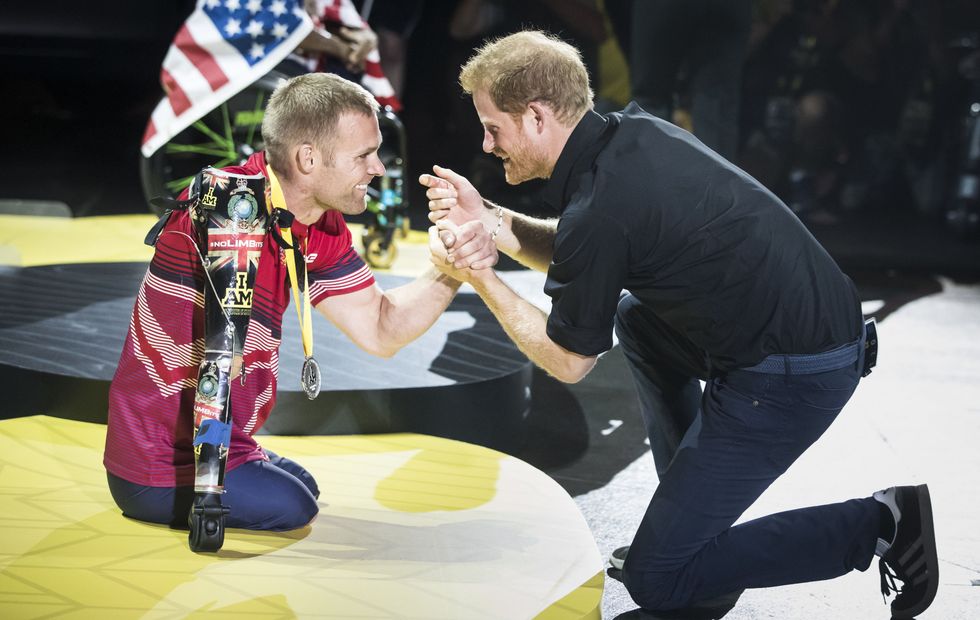 Prince Harry presents a Invictus Games medal to the United Kingdom's Mark Ormrod after he won sliver in Toronto 2017