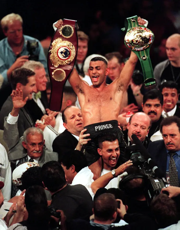 Prince Naseem Hamed of Sheffield, England, carries both the WBO and WBC belts after defeating Ceasar Soto of Juarez City at Joe Louis Arena in Detroit, Michigna 22 October, 1999. WBO featherweight champion Prince Naseem Hamed won by unanimous decision over WBC titleholder Cesar Soto in their 12-round unification bout.       AFP Photo/Jeff KOWALSKY (Photo by JEFF KOWALSKY / AFP)        (Photo credit should read JEFF KOWALSKY/AFP via Getty Images)