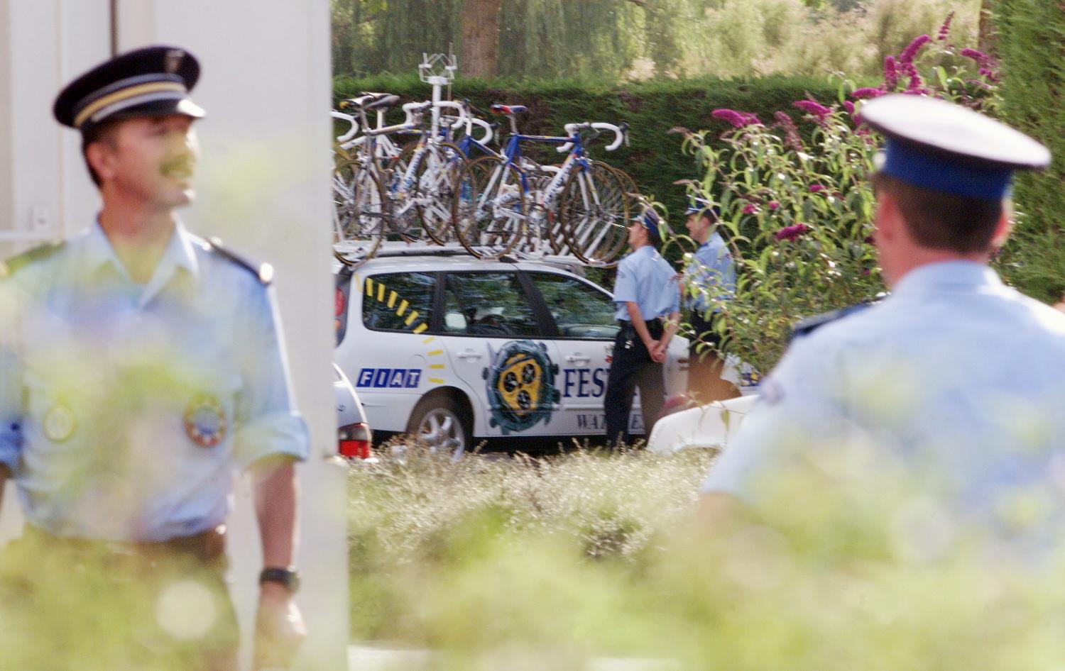 CHOLET - JULY 15: Policemen stay nearby Festina team sportive director Bruno Roussel&amp;apos;s car in Cholet, West of France on July 15, 1998 as he is questioned about doping. (ELECTRONIC IMAGE) (Photo by JOEL SAGET/AFP via Getty Images)
