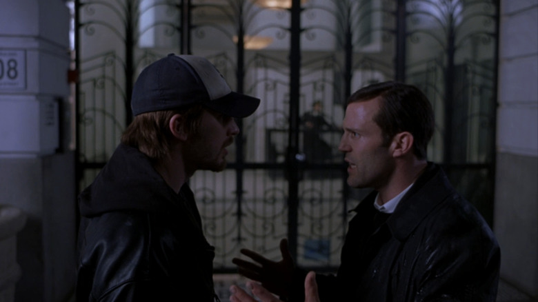 Chris Evans' Syd stands opposite Jason Statham's Bateman outside in London