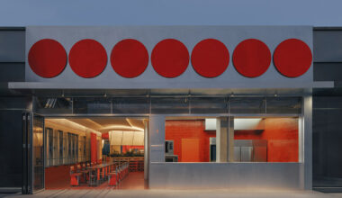 circular red panels line the facade of café by aptdotapt in china