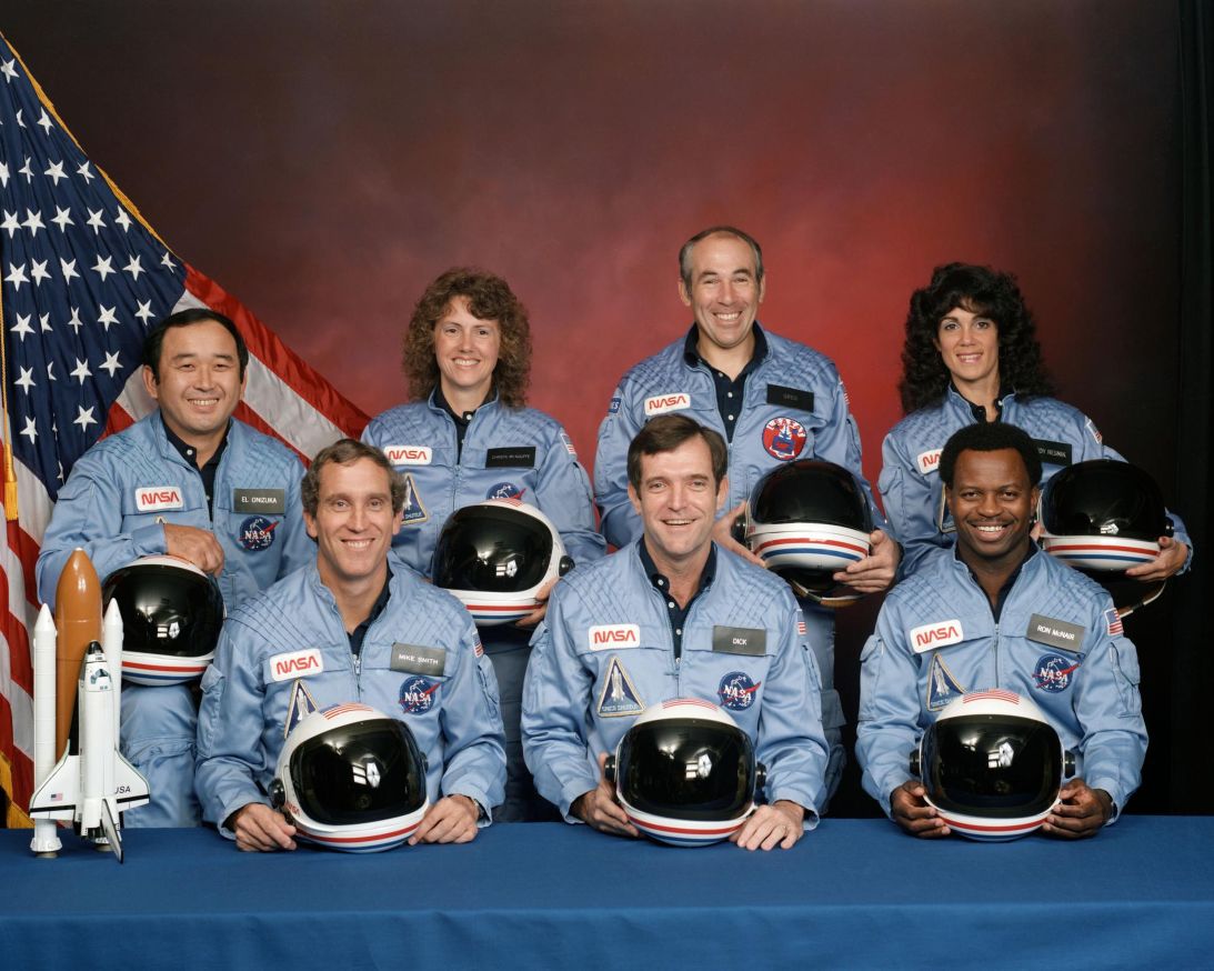 Challenger crew members (left to right, front row) Michael J. Smith, Francis R. (Dick) Scobee and Ronald E. McNair, (back row, left to right) Ellison S. Onizuka, Sharon Christa McAuliffe, Gregory Jarvis and Judith A. Resnik pose together in December 1985.