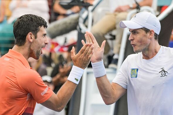 Djokovic and Vasek Pospisil shake hands