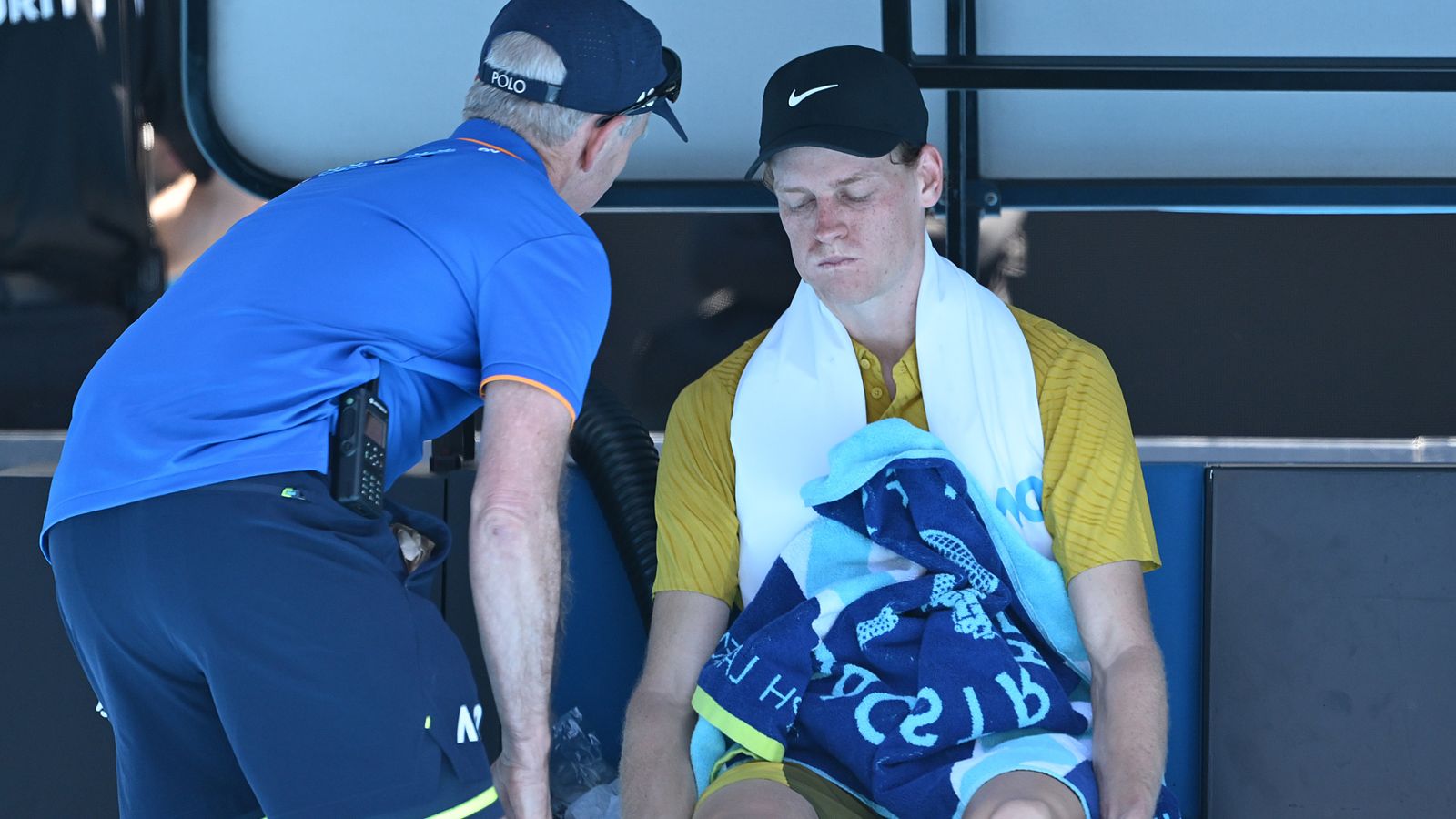 Jannik Sinner of Italy receives medical treatment in the Men's Singles Third Round against Eliot Spizzirri of the United States during day s