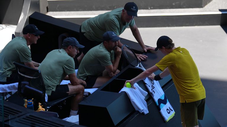 Jannik Sinner of Italy rests at his coaching box during his third round match against Eliot Spizzirri of the U.S. at the Australian Open ten