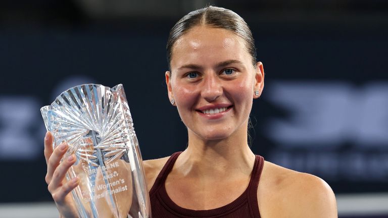 Marta Kostyuk poses with the runner-up trophy after losing to Aryna Sabalenka in the 2026 Brisbane International final (AP)
