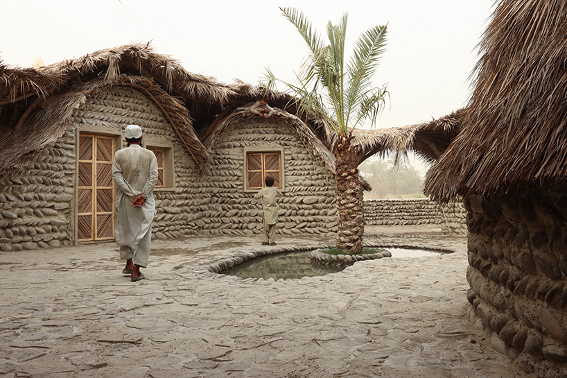 vaulted palm canopy shields dry stone guesthouse cluster in southeastern iran