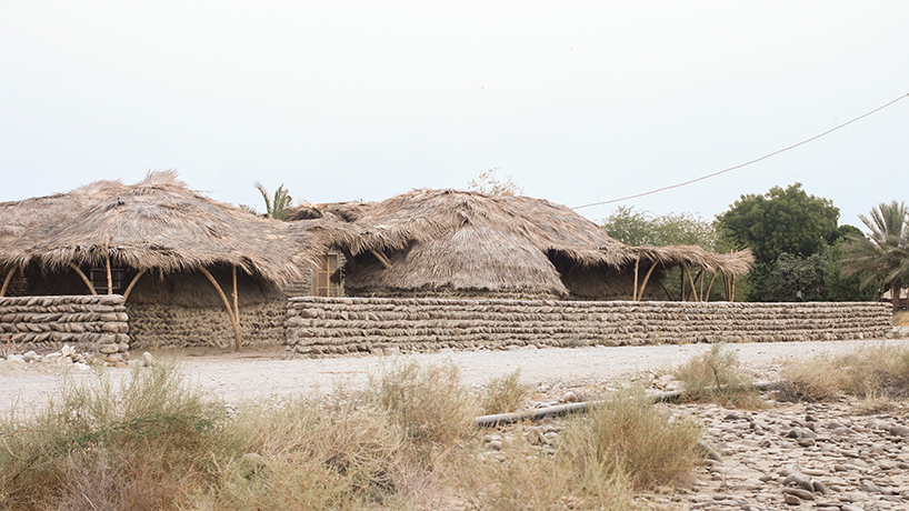 vaulted palm canopy shields dry stone guesthouse cluster in southeastern iran