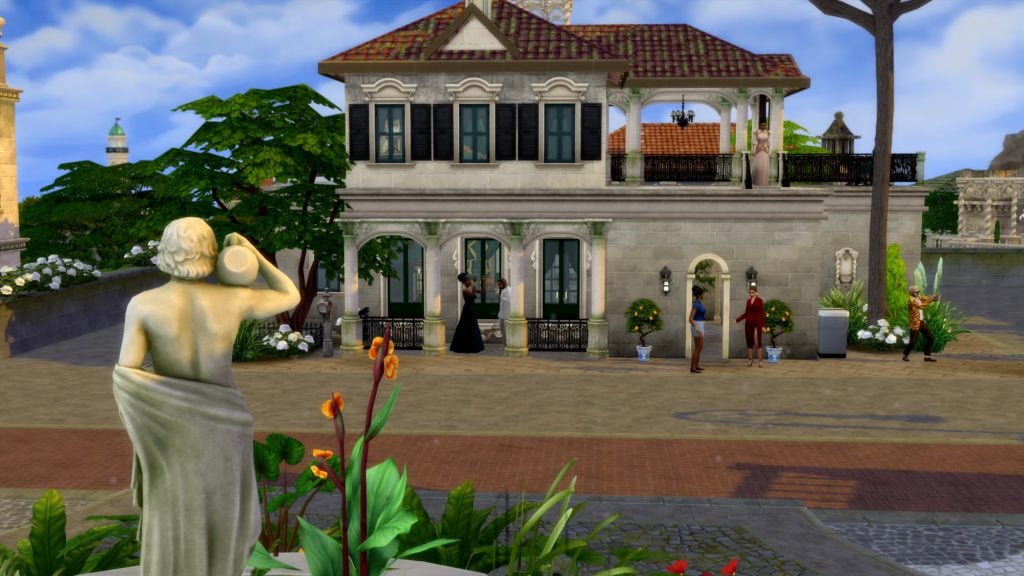 Sims gather outside a stone villa with arched doorways and balconies, as a classical statue overlooks a lively town street.