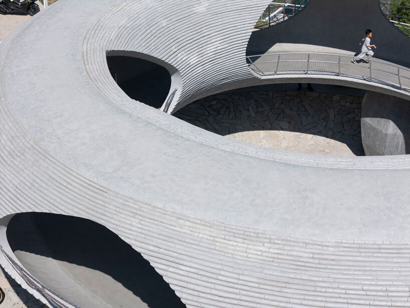 tubular concrete ring by HCCH studio shapes cycling rest pavilion among chinese hills