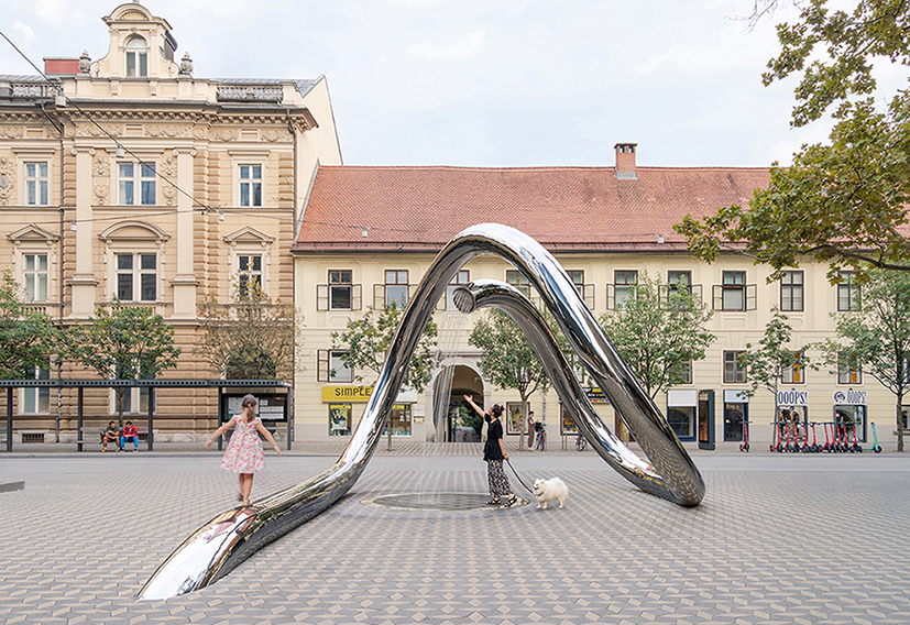 continuous steel loop forms water sculpture reflecting ljubljana’s urban fabric