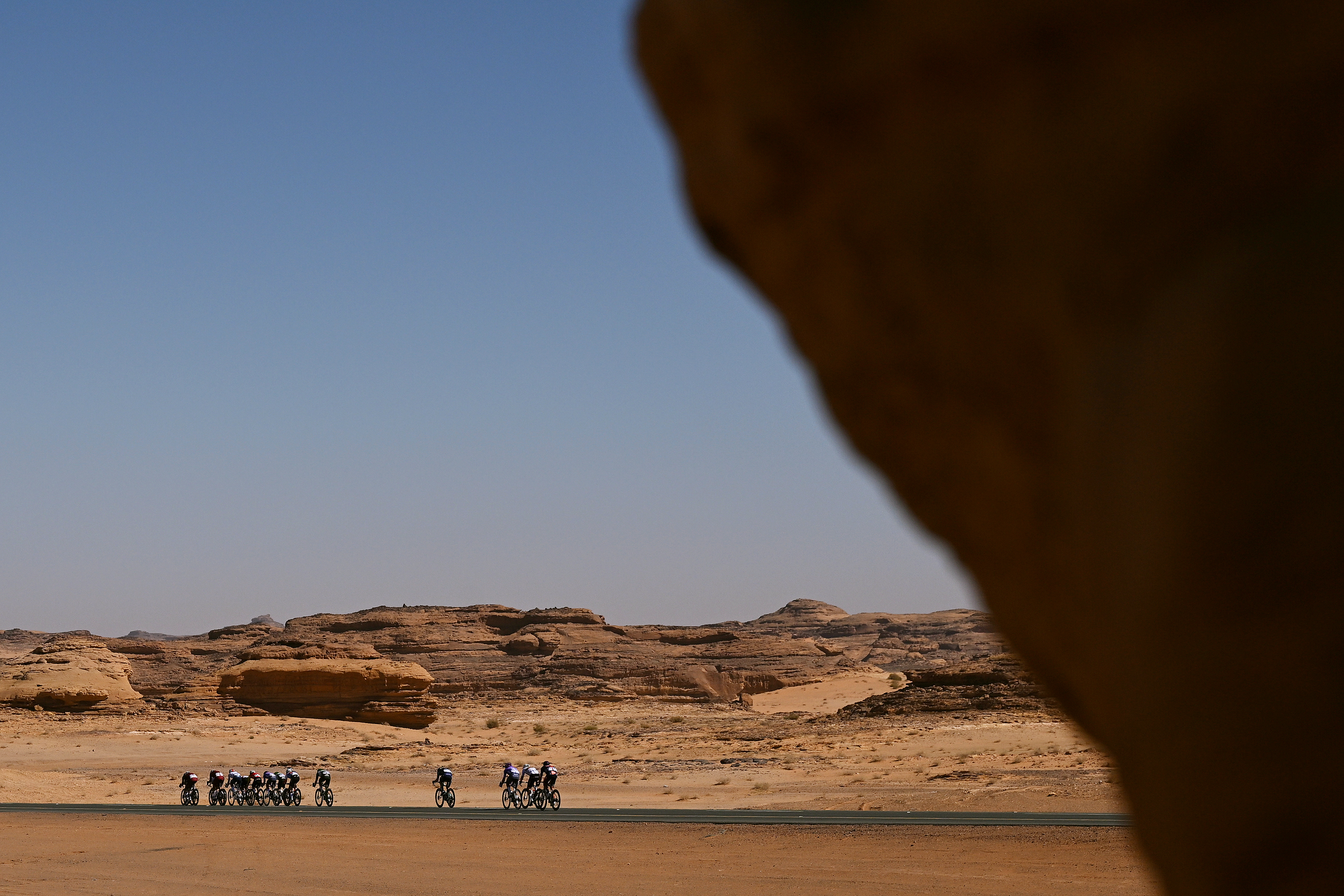 HEGRA, SAUDI ARABIA - JANUARY 30: A general view of Alessandro Borgo of Italy and Team Bahrain Victorious, Emils Liepins of Latvia and Pinarello Q36.5 Pro Cycling Team, Dries De Bondt of Belgium, Paul Double of Great Britain and Jayco AlUla, Julius Johansen of Denmark and UAE Team ADQ, Martin Svrcek of Slovakia and Team Soudal Quick-Step, Timo De Jong of Netherlands and Team Picnic PostNL, Aivaras Mikutis of Lithuania and Team Tudor Pro Cycling, Jamie Meehan of Ireland and Team Cofidis, Mathis Le Berre of France and Team TotalEnergies, Julen Arriolabengoa of Spain, Sebastian Berwick of Australia and Team Caja Rural - Seguros RGA, Robin Carpenter of United States, Sean Christian of United States and Team Modern Adventure Pro Cycling, Federico Iacomoni of Italy and Team UKYO and Mathias Bregnhoj of Denmark and Terengganu Cycling Team compete in the breakaway during the 6th AlUla Tour 2026, Stage 4 a 173,4 km stage from Winter Park - Alula to Hegra - Shalal Sijyat Rocks 785m on January 30, 2026 in Hegra, Saudi Arabia. (Photo by Dario Belingheri/Getty Images)