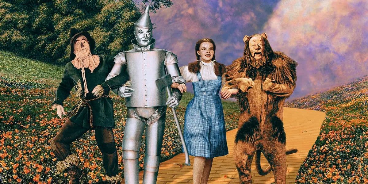 Scarecrow, Tin Man, Dorothy, and the Cowardly Lion walk down the Yellow Brick Road together