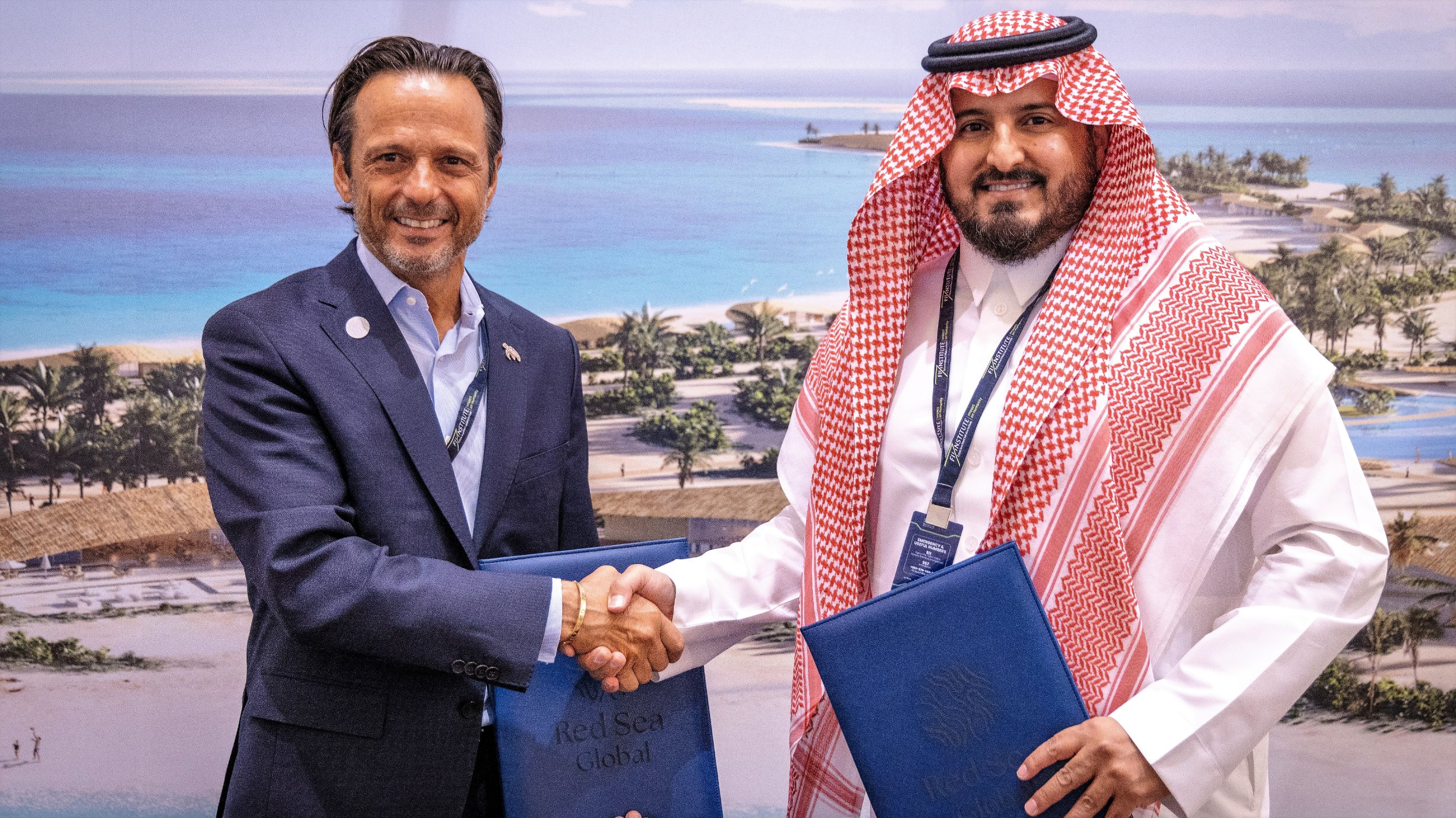 John Pagano shaking hands with Gelban Al-Gelban after signing an agreement.