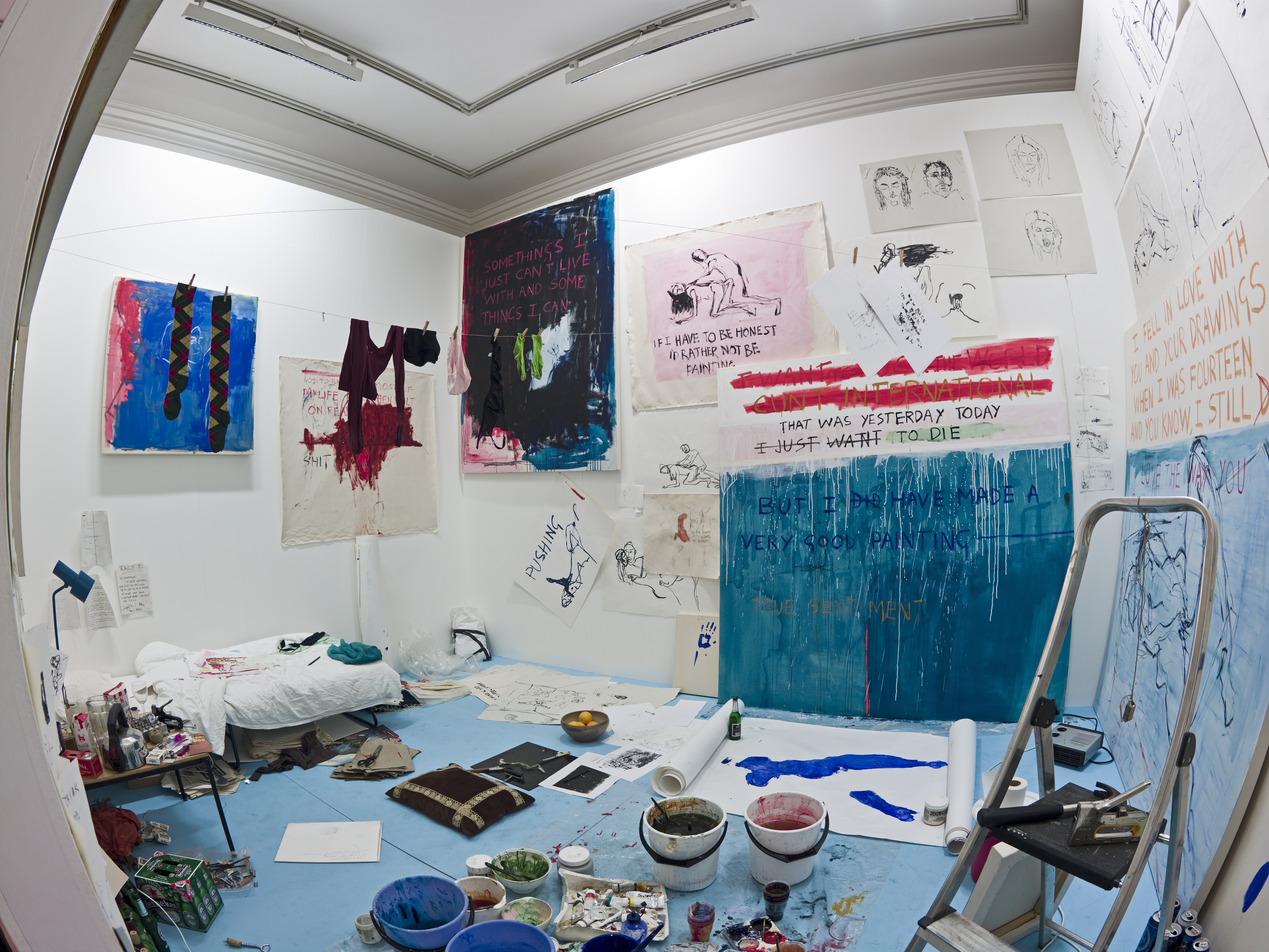 "Exorcism of the last painting I ever made" by Tracey Emin, depicting a messy room filled with paintings, drawings, and personal belongings.