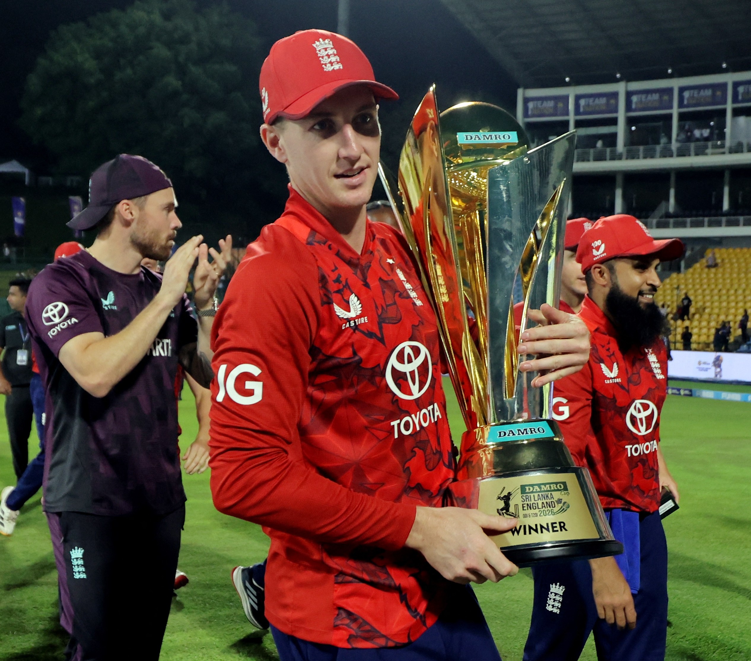 England's Harry Brook celebrates with the trophy after winning the cricket series.