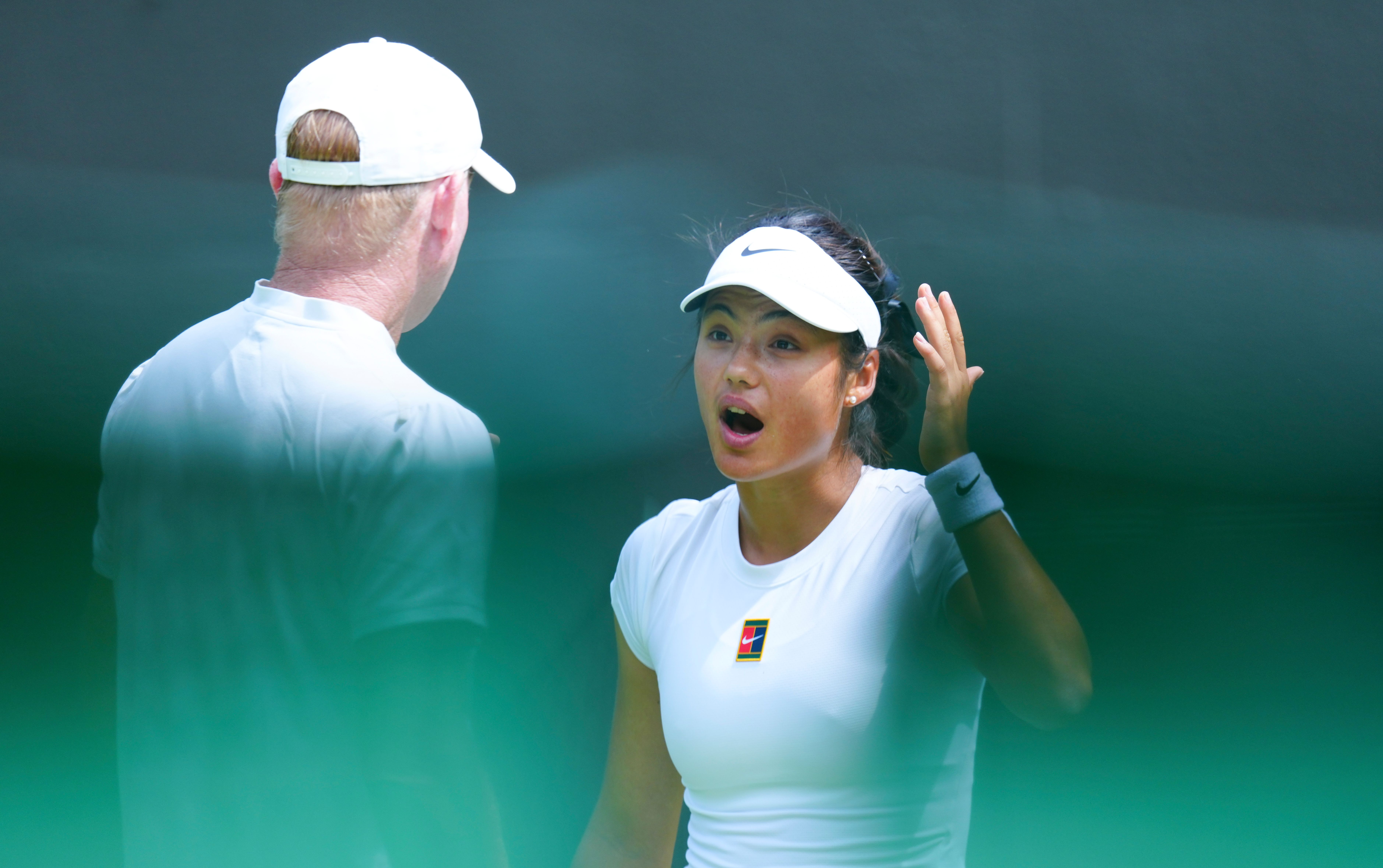 Emma Raducanu reacts to coach Mark Petchey during practice.