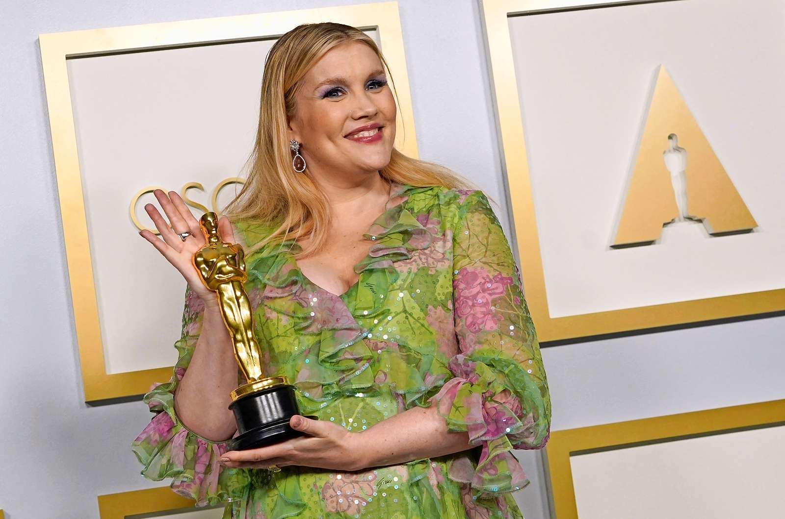 Emerald Fennell, winner of the Best Original Screenplay Oscar, poses with her award.