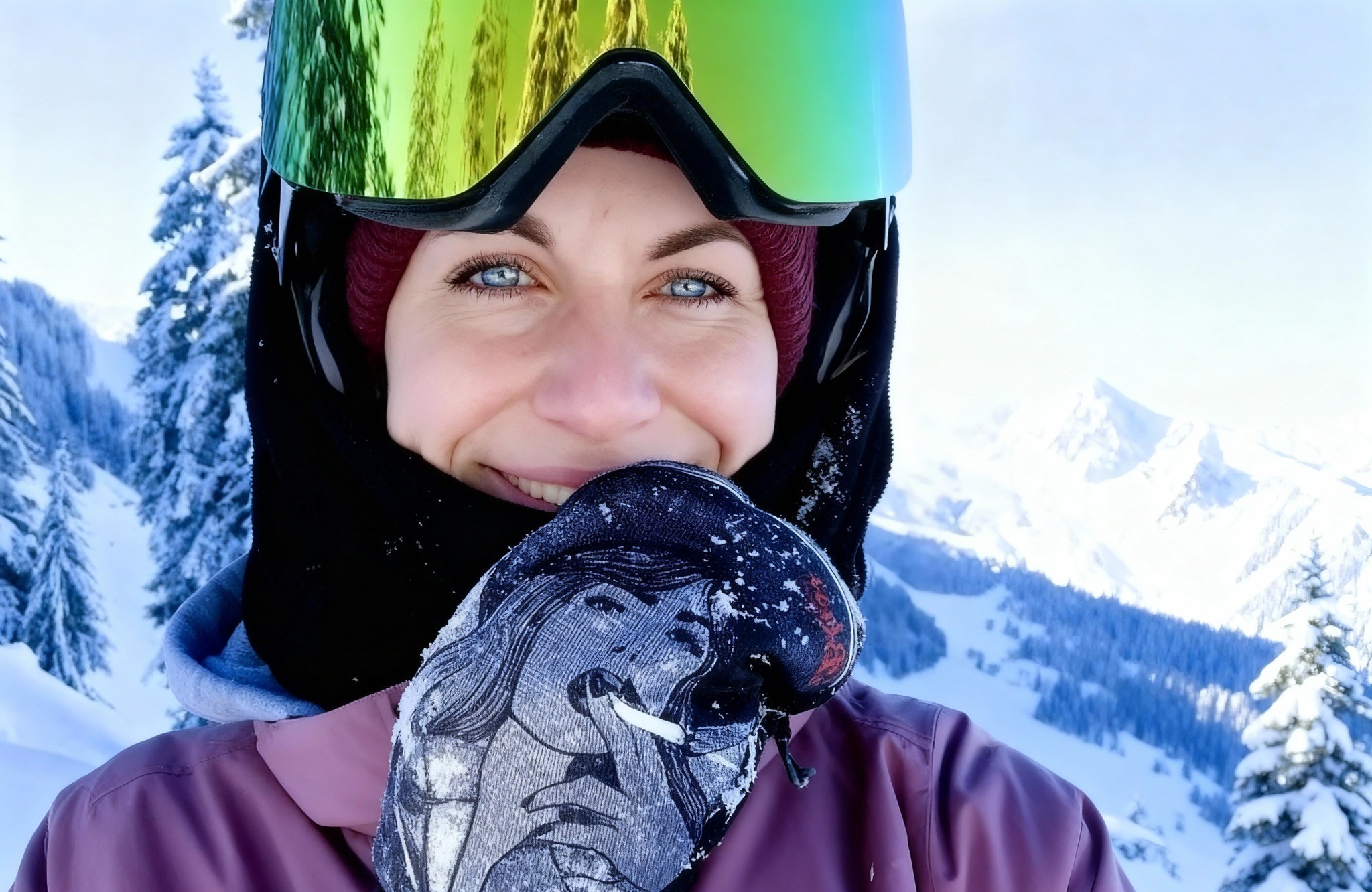 Kerstin Gurtner, a 33-year-old woman, dressed in winter gear, smiling in a snowy mountain landscape.