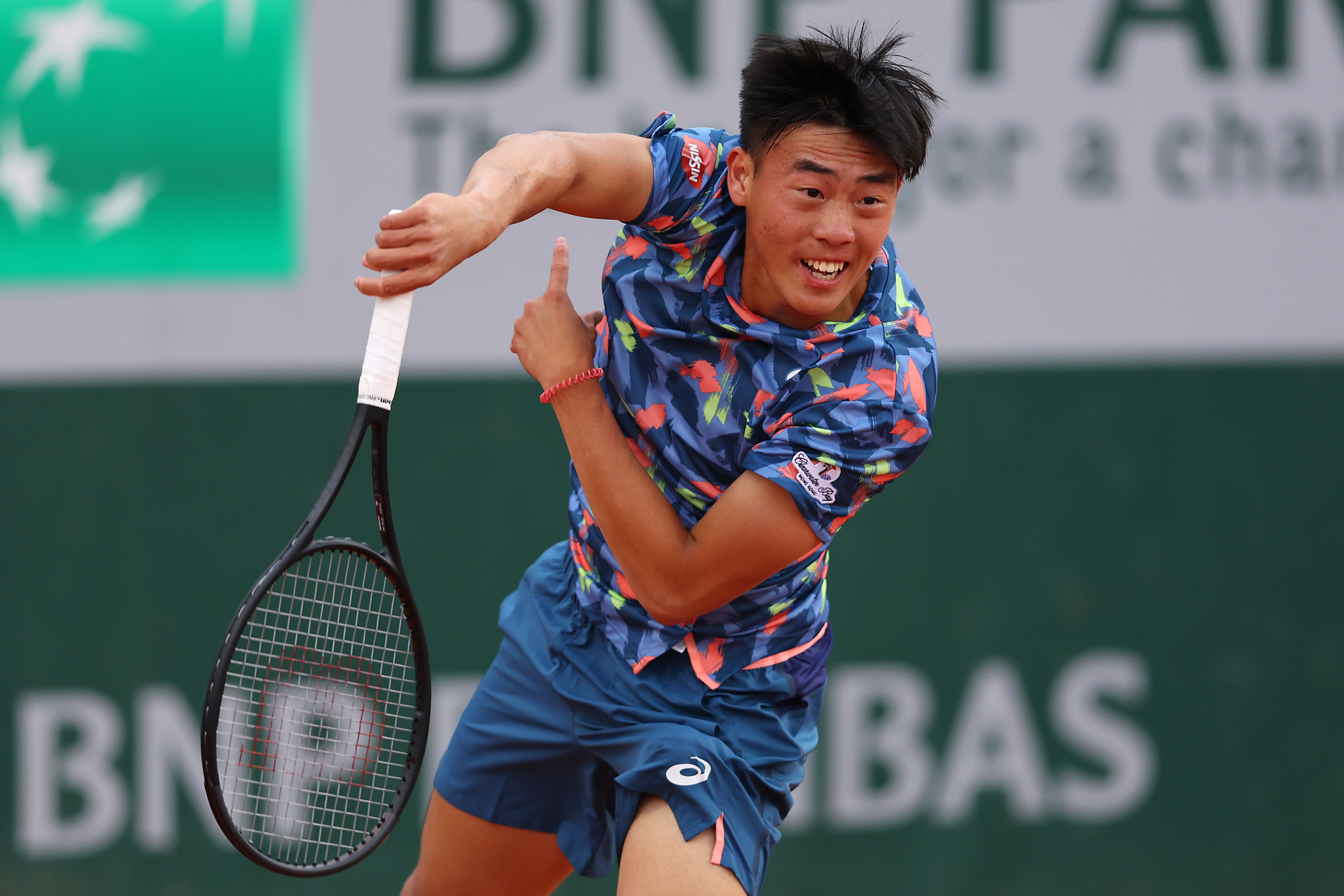 Chak Lam Coleman Wong of Hong Kong serving during the Boy's Singles First Round match at the 2022 French Open.