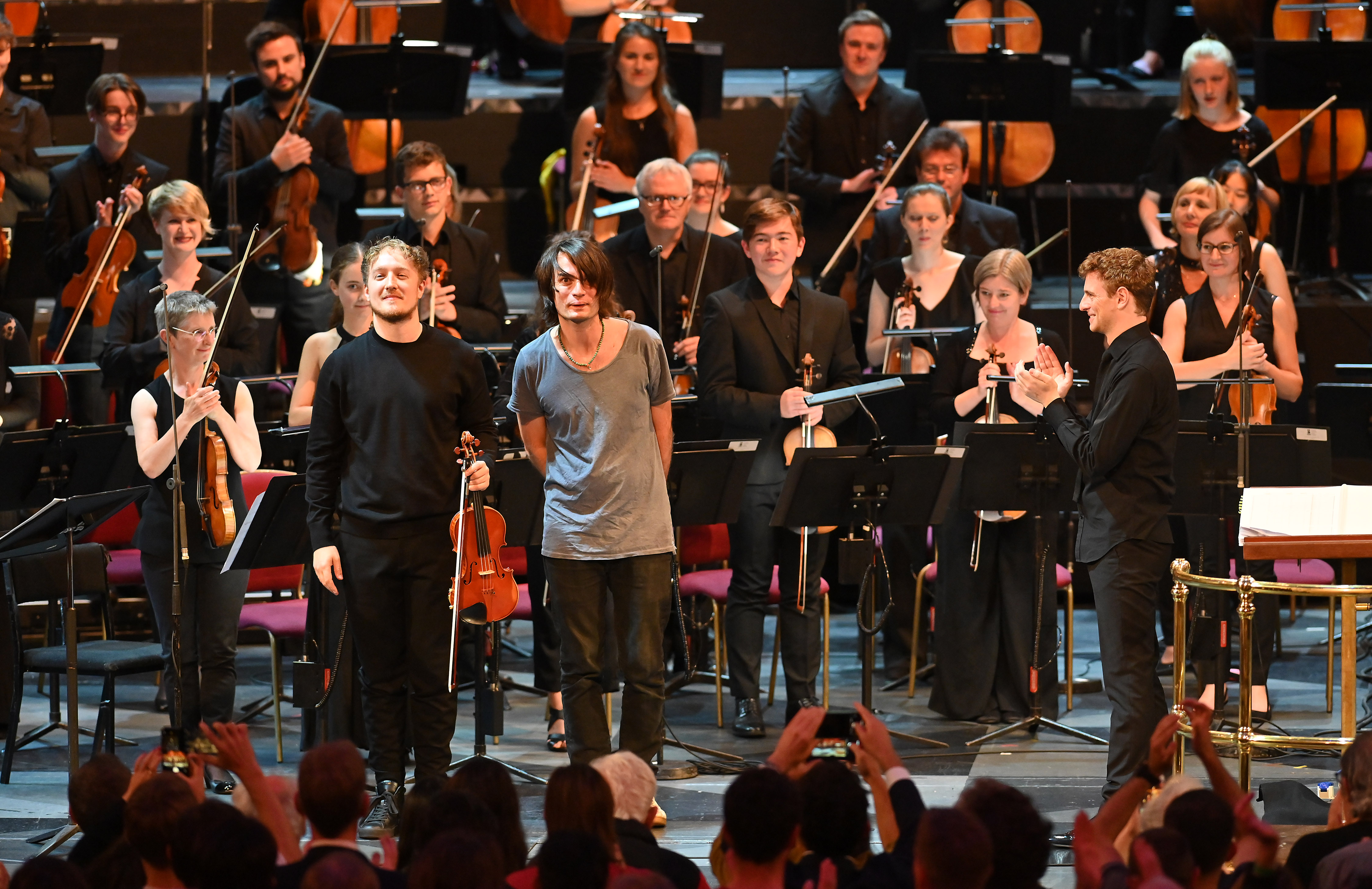 Jonny Greenwood and Daniel Pioro acknowledging applause after the world premiere of Horror vacui.