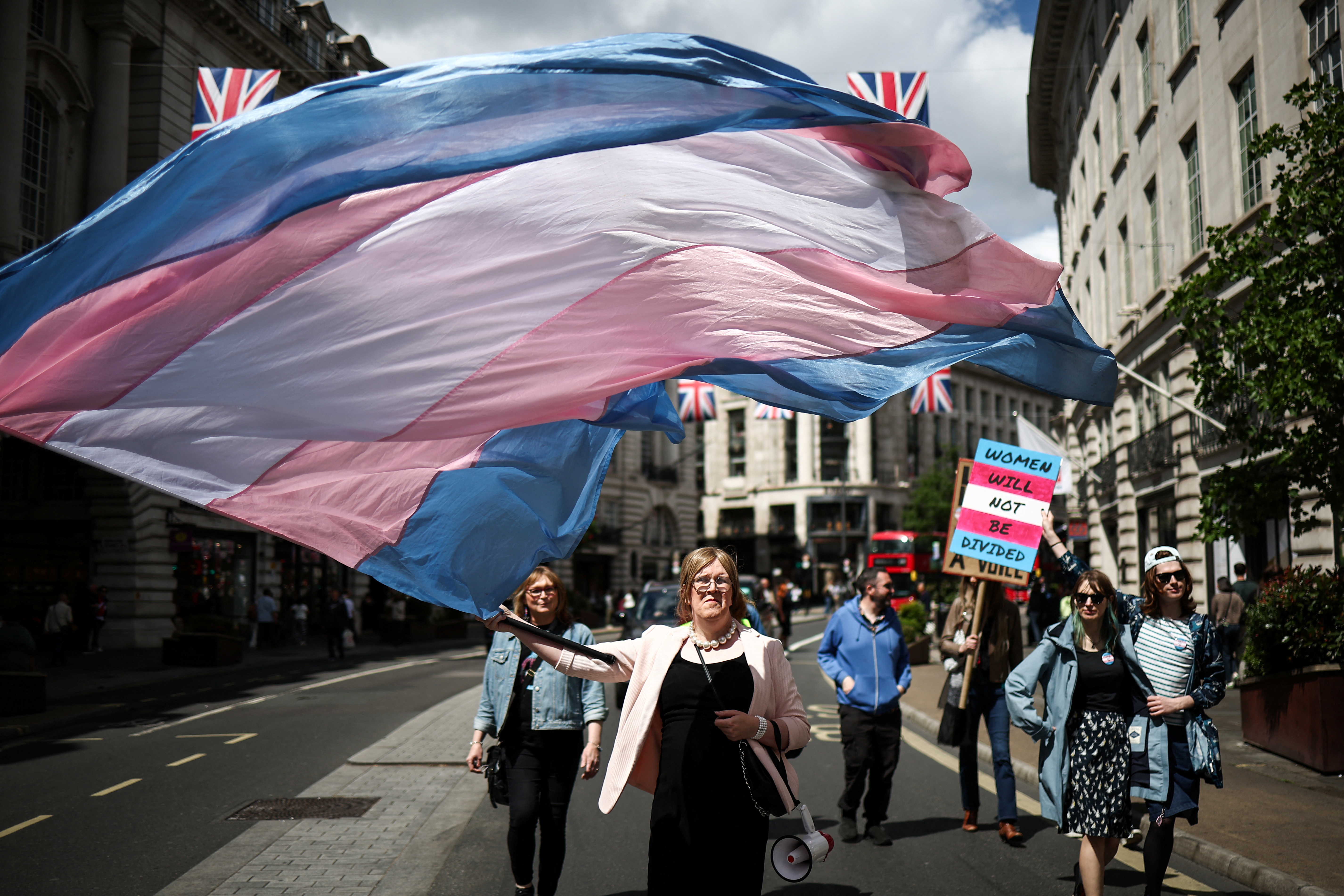 A protester waves a transgender pride flag during a march in central London.