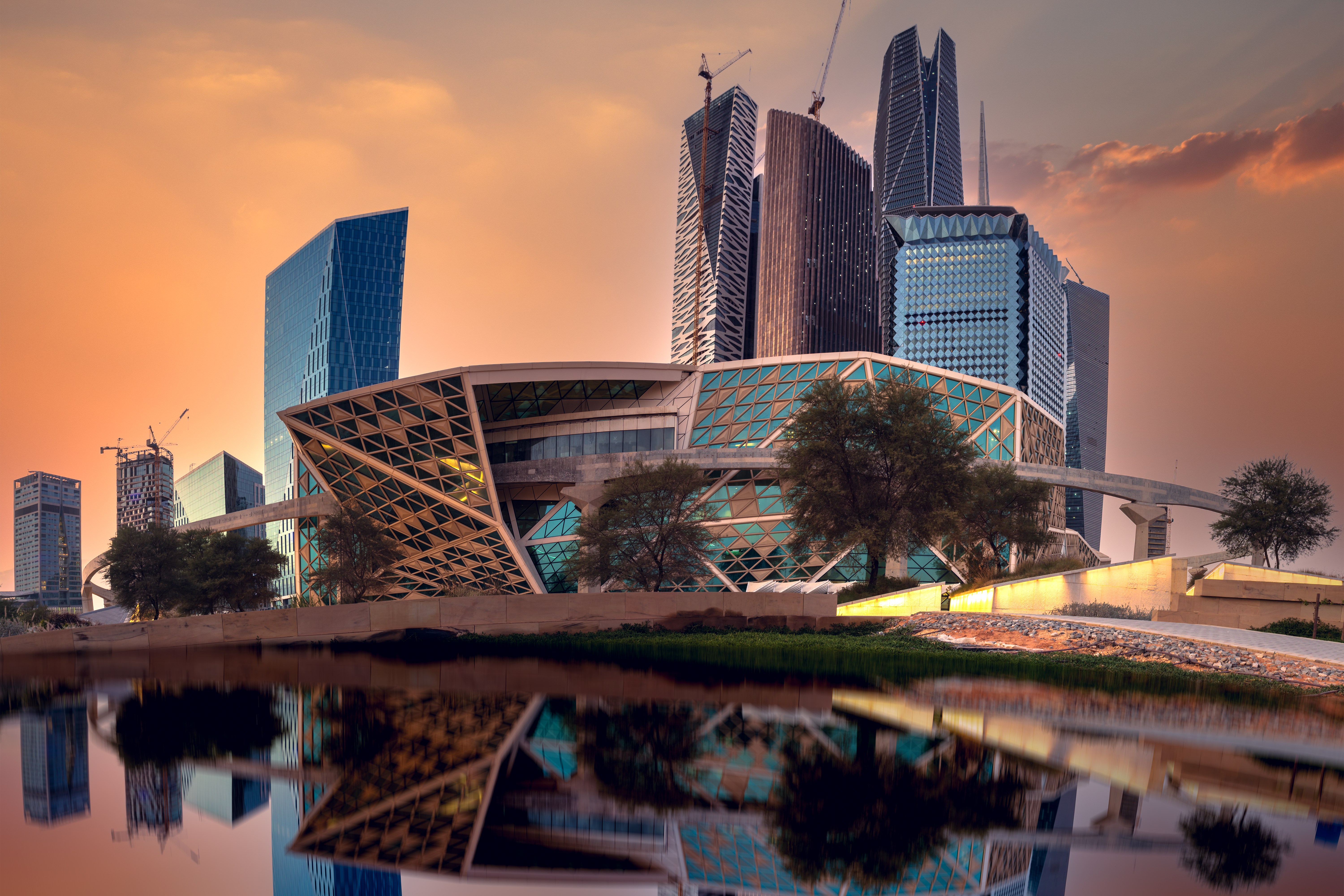 King Abdullah Financial District in Riyadh, Saudi Arabia, with modern high-rises reflecting on a body of water.