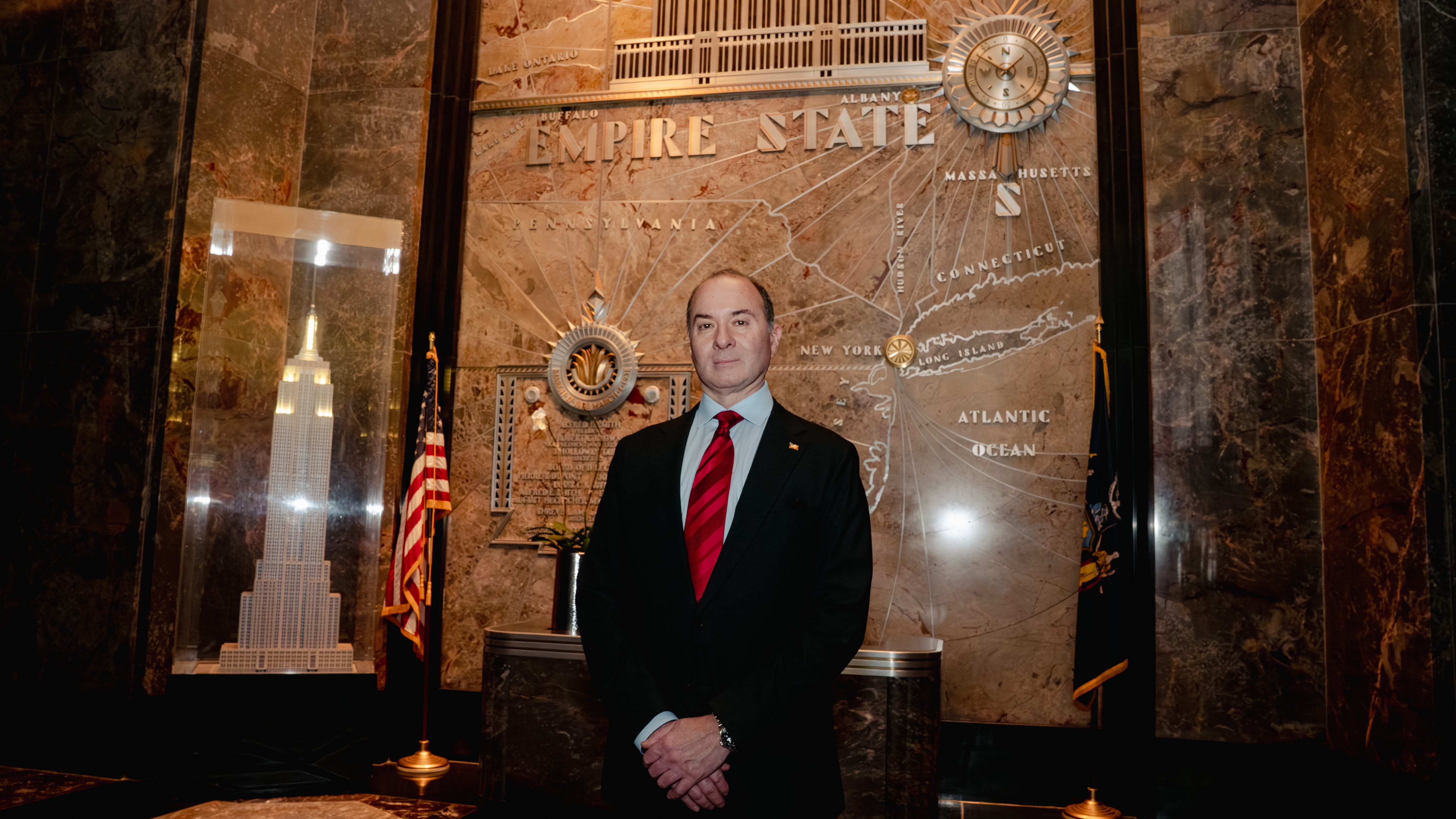 Juda Engelmayer posing in the lobby of the Empire State Building.
