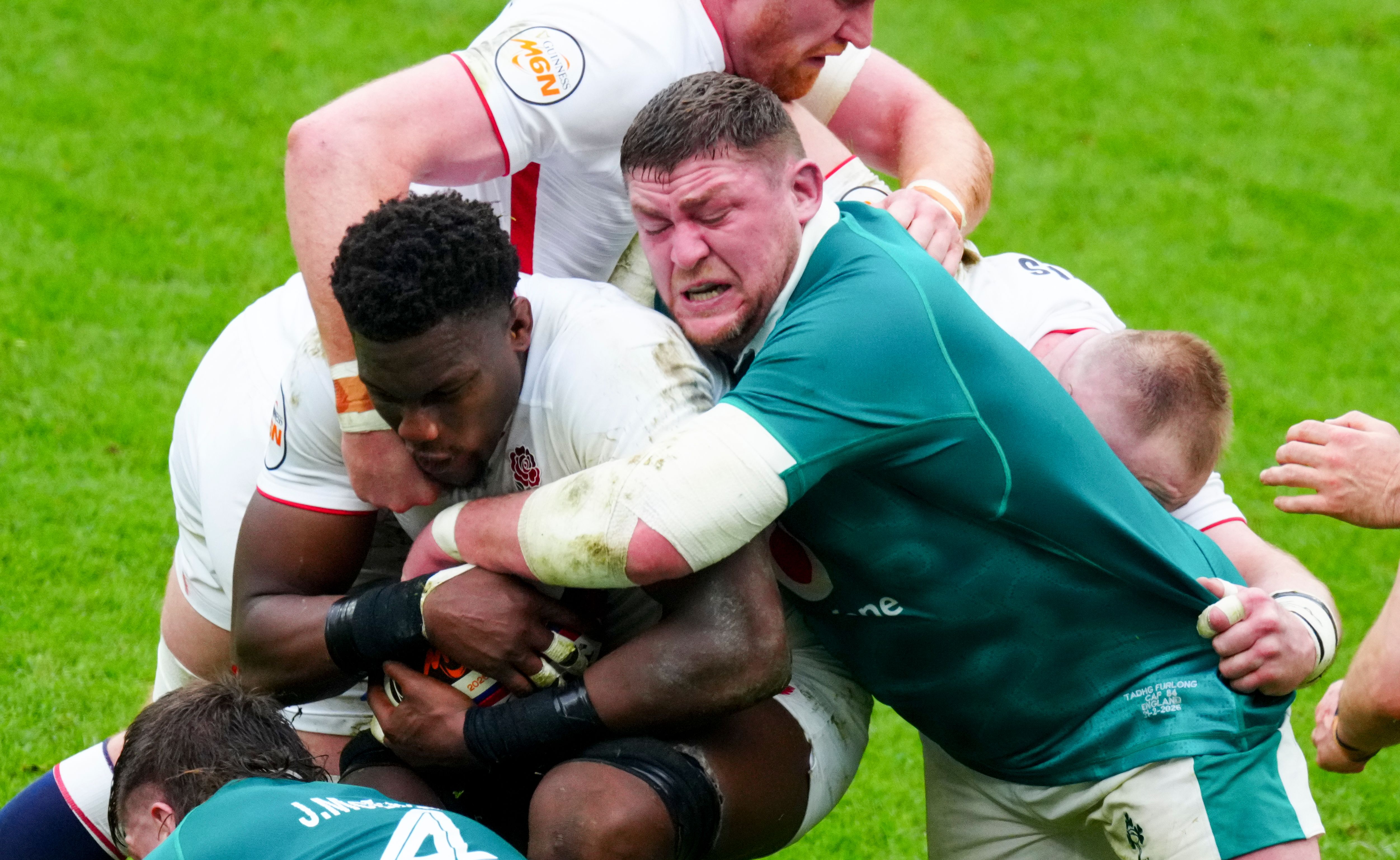 Tadhg Furlong of Ireland tackles Maro Itoje of England during a rugby match.