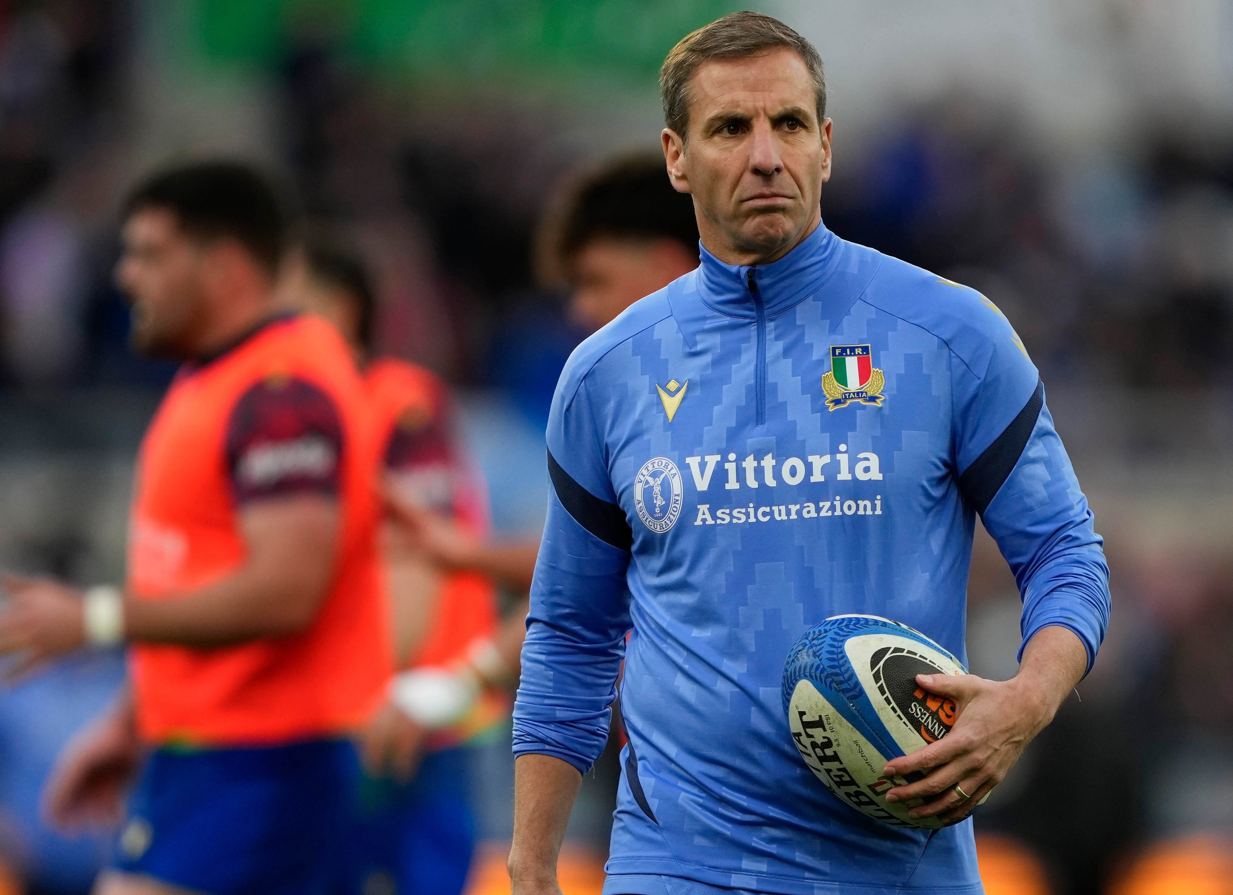 Italy head coach Gonzalo Quesada holding a rugby ball during the Guinness Six Nations 2026 match against Scotland.