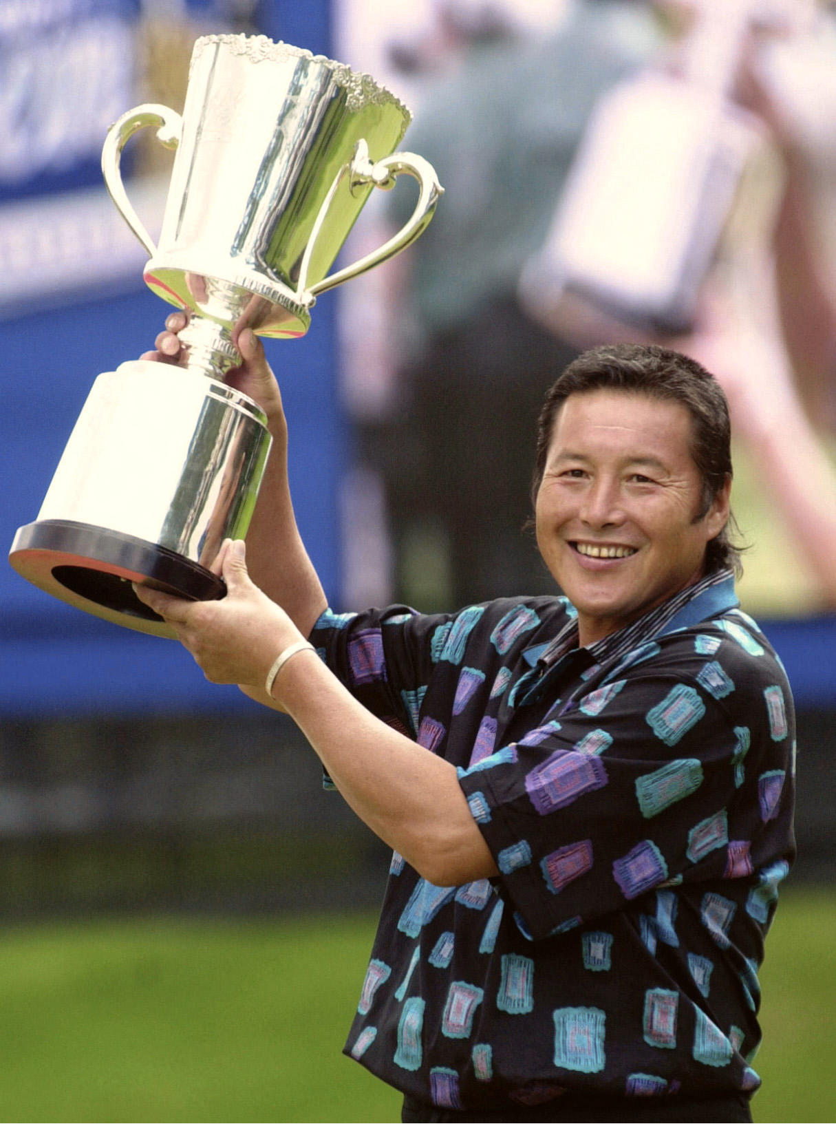 Masashi Ozaki holding up the trophy after winning the ANA Open golf competition.