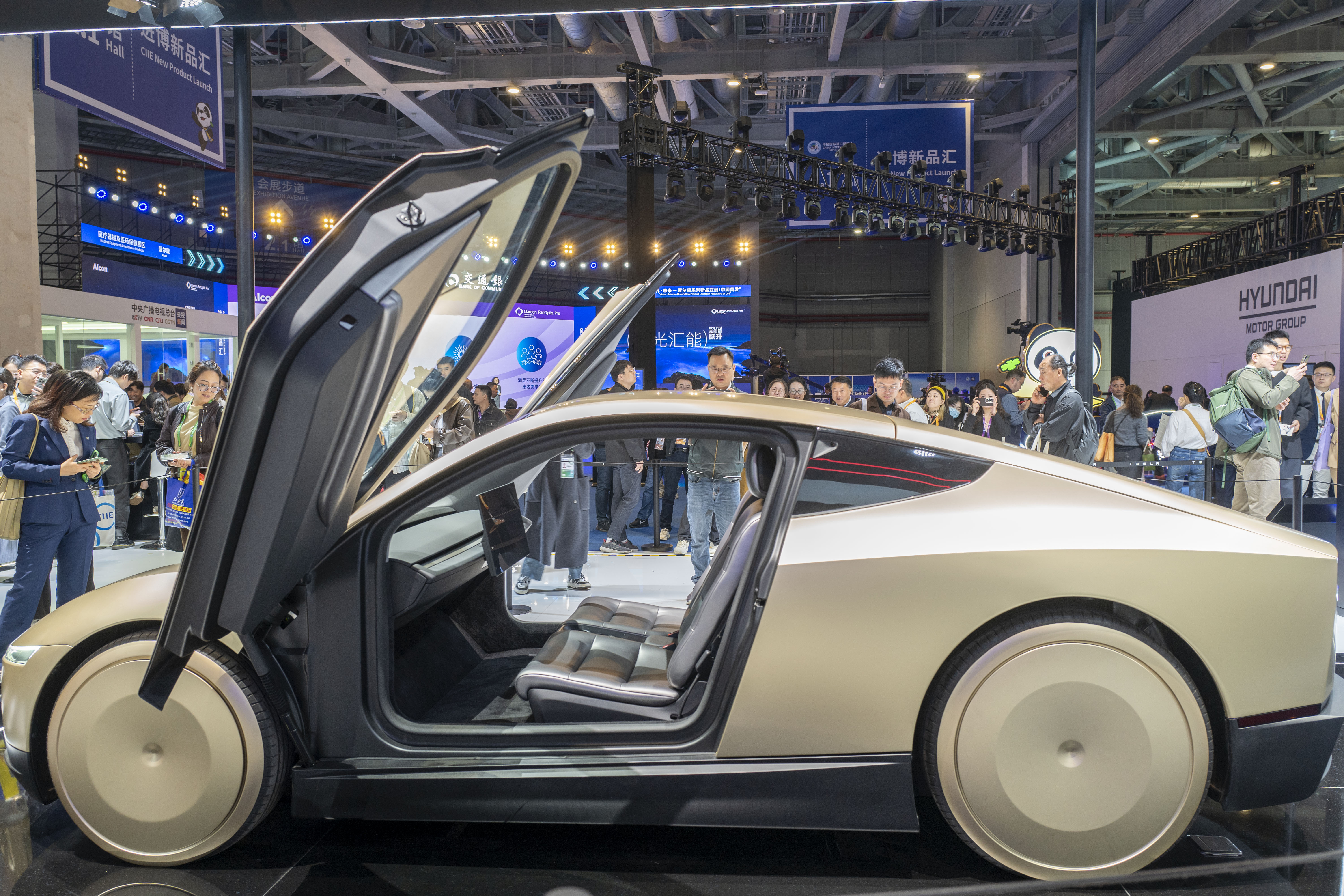 Tesla Cybercab self-driving car on display with its doors open at the China International Import Expo in Shanghai.