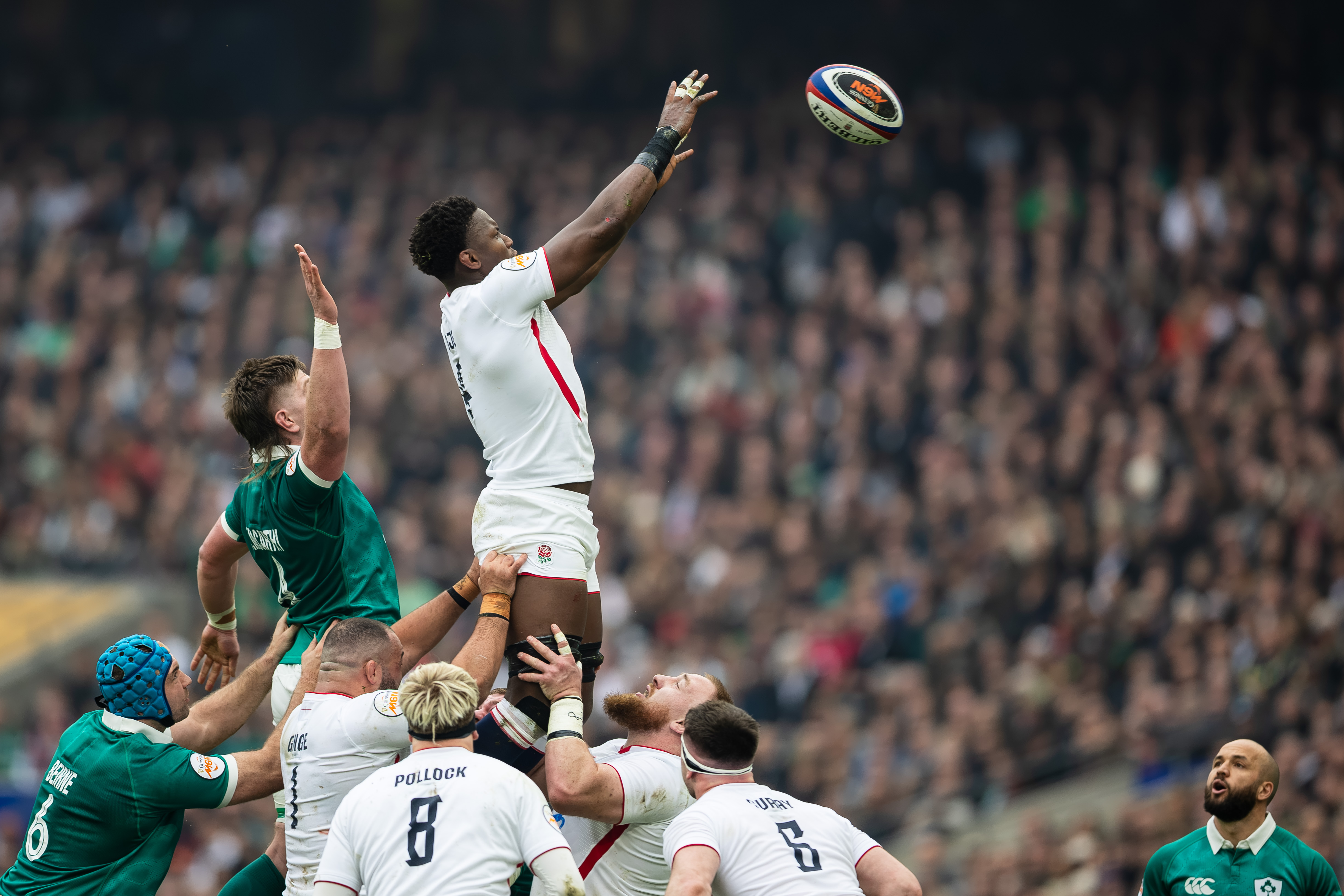Maro Itoje of England leaps high to claim the lineout during a rugby match against Ireland.