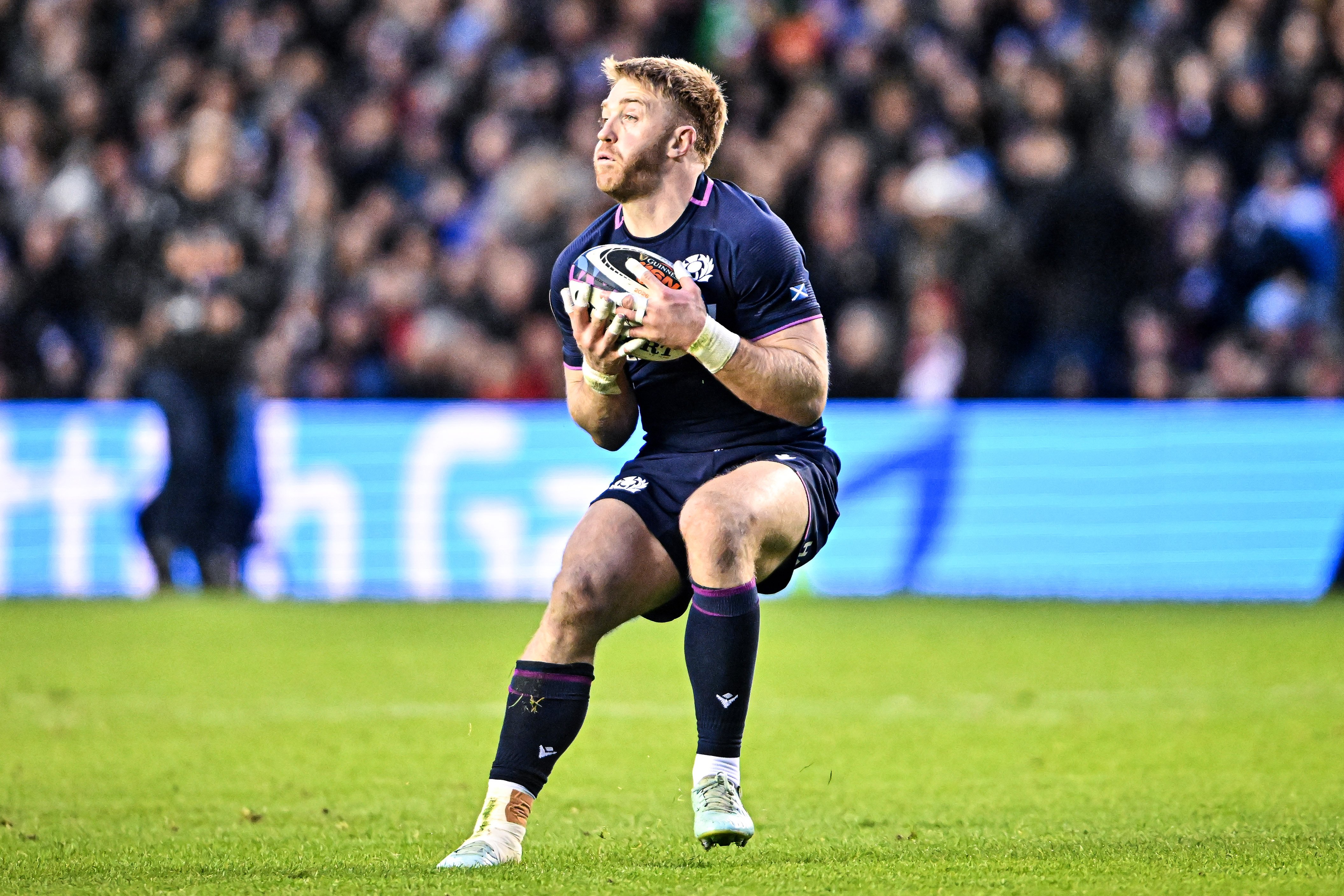 Kyle Steyn of Scotland holds a rugby ball during a Six Nations match.