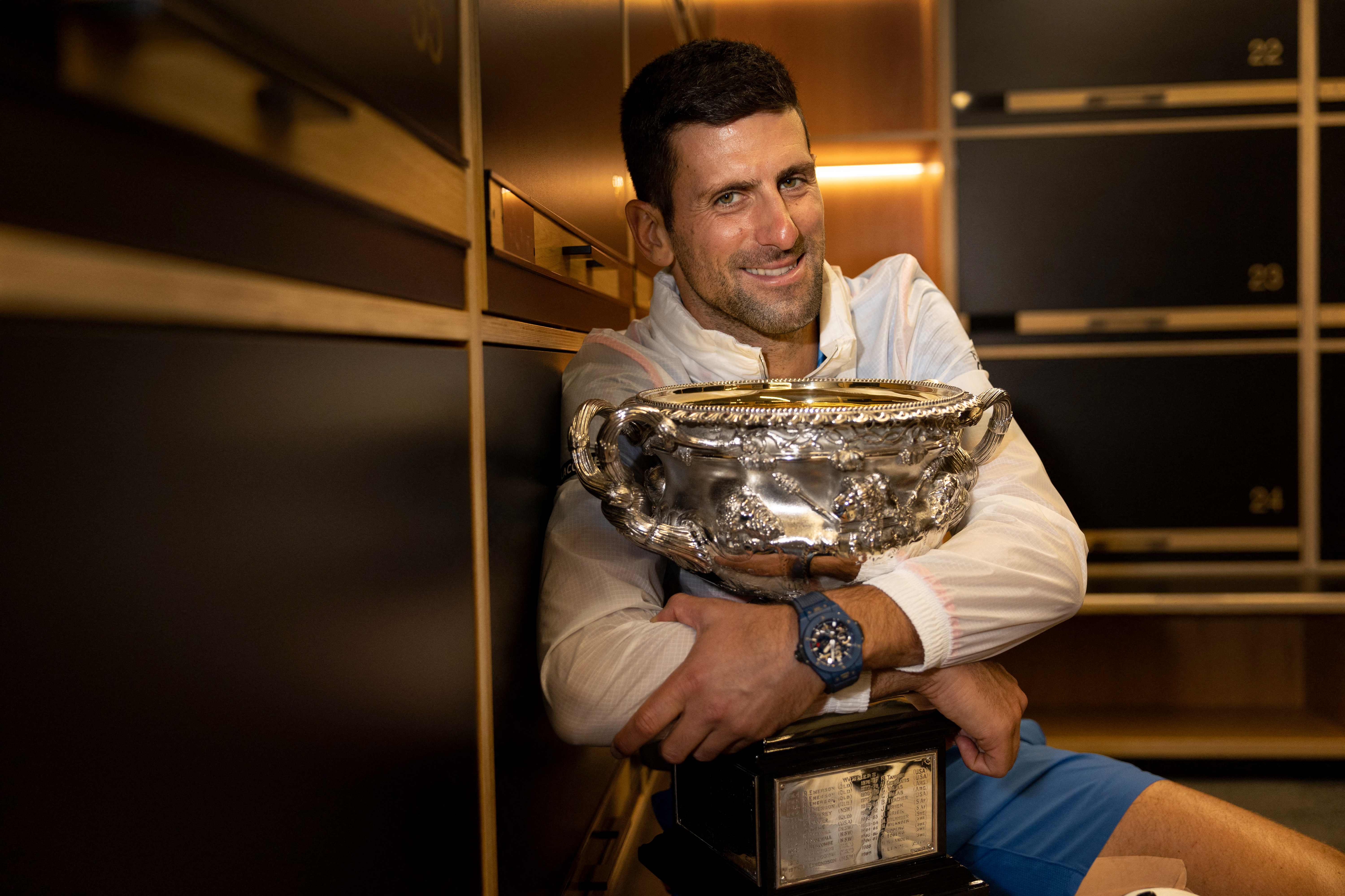 Novak Djokovic with the 2023 Australian Open men's singles final trophy in the locker room.