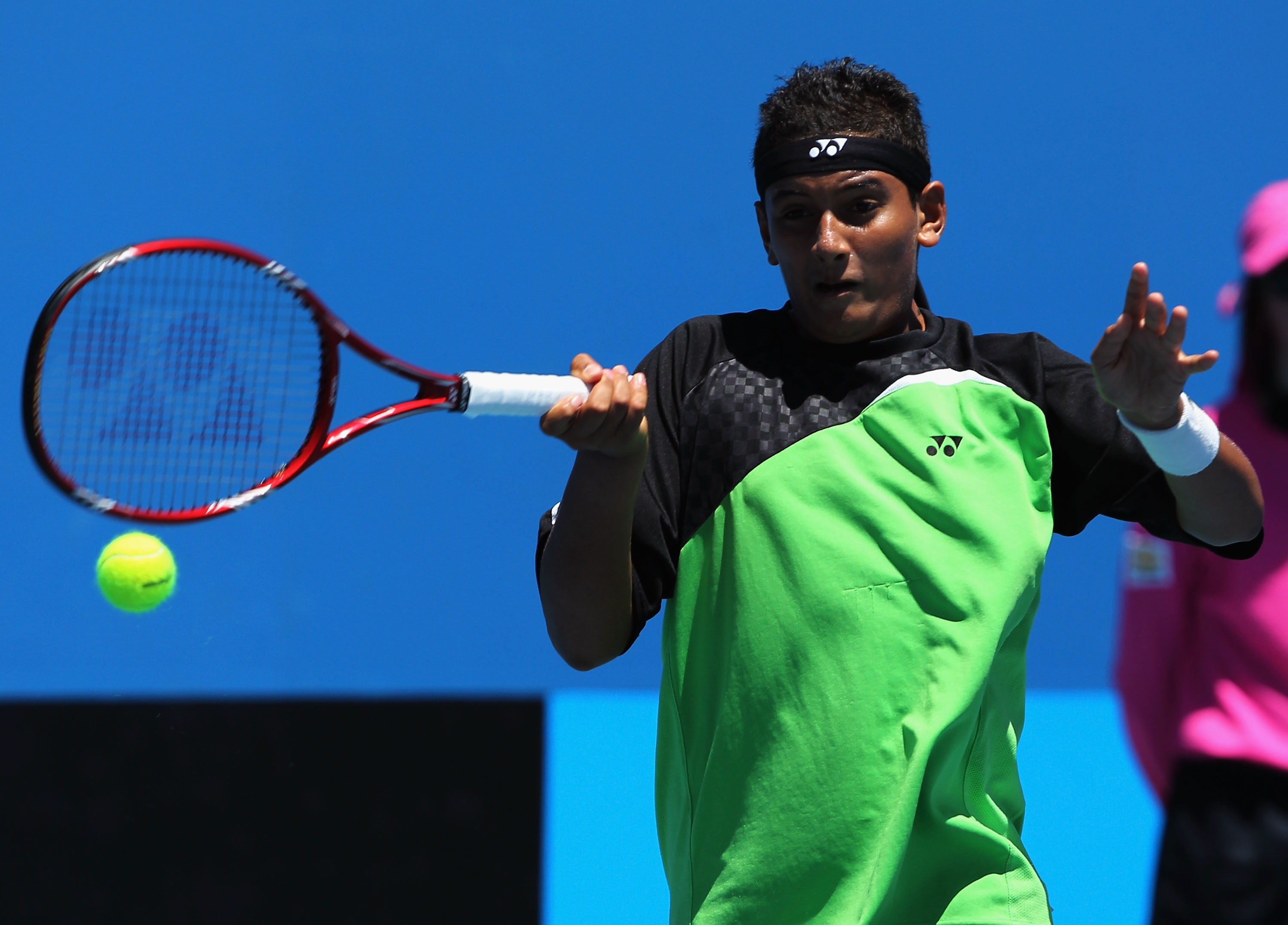 Nick Kyrgios plays a forehand in his junior doubles match.