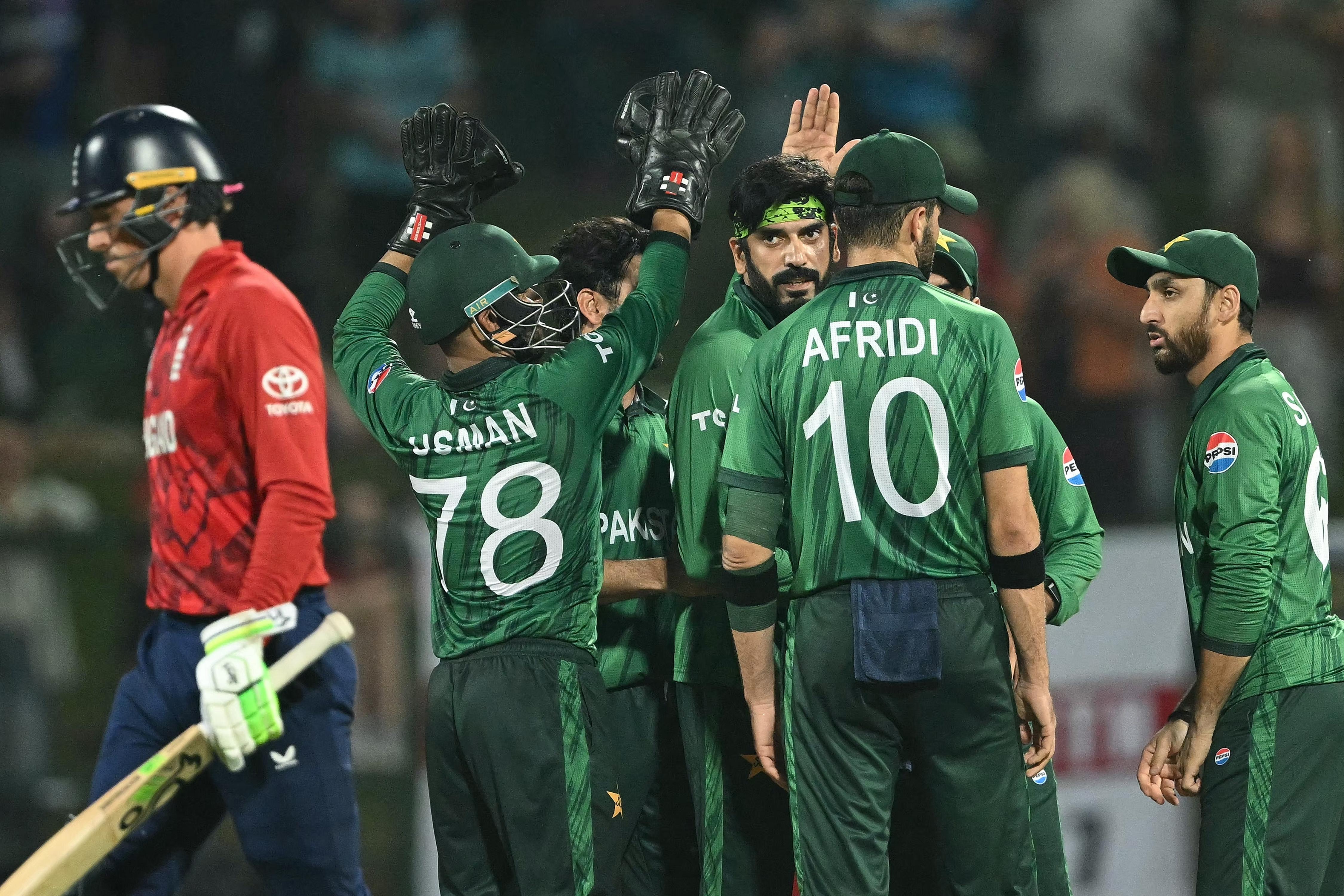 Pakistan cricket players celebrate after taking a wicket against England.