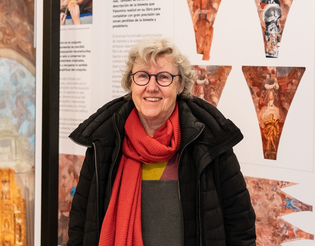 Pilar Roig stands in front of displays about the restoration of the 17th-century ceiling frescoes and stucco work at Valencia’s central Santos Juanes Church.