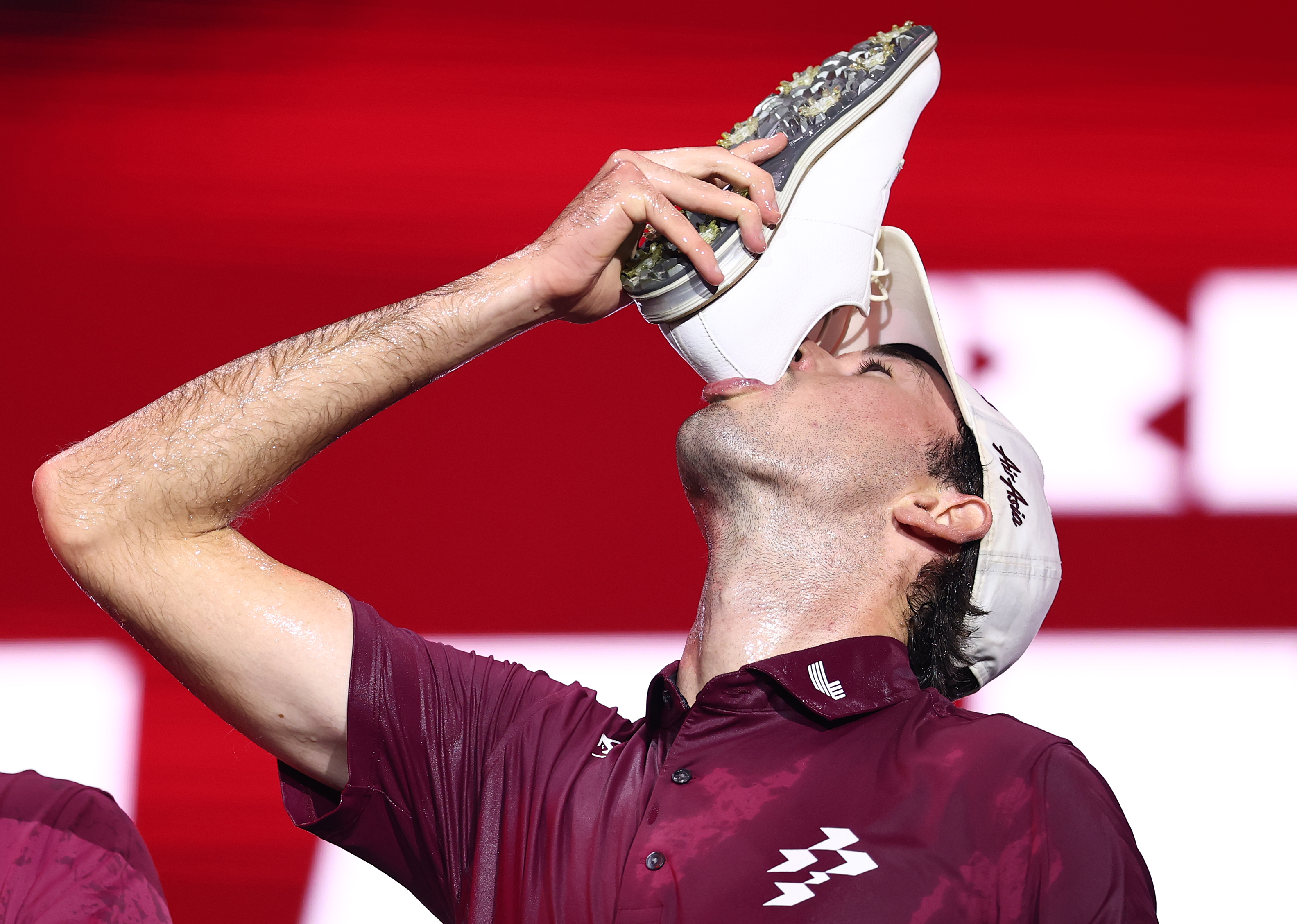 Elvis Smylie of Ripper GC celebrates winning the LIV Golf Riyadh by drinking from a shoe.