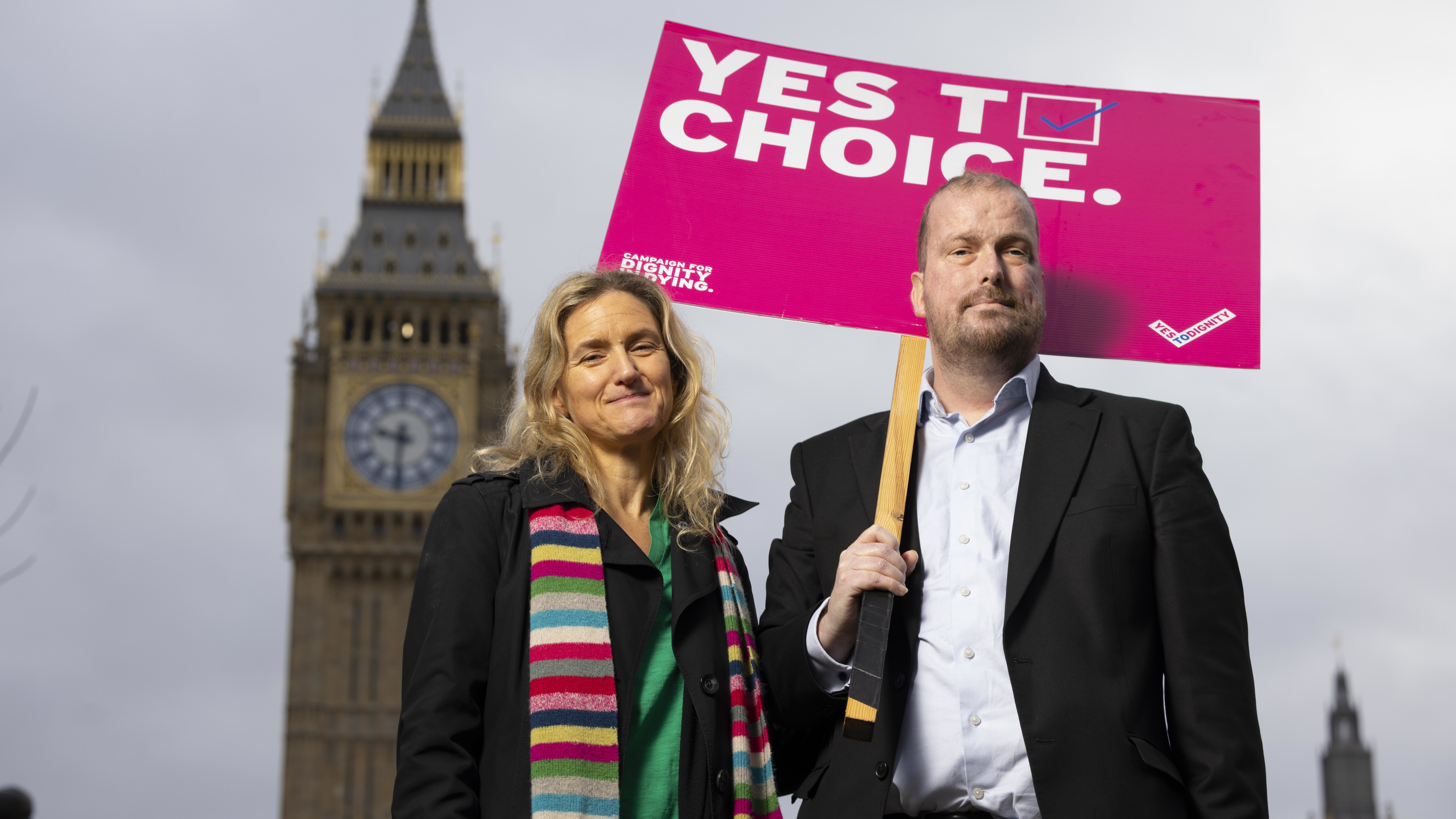 Nathaniel Dye and MP Kim Leadbeater campaigning for Dignity in Dying with a "YES TO CHOICE" sign in front of Big Ben.