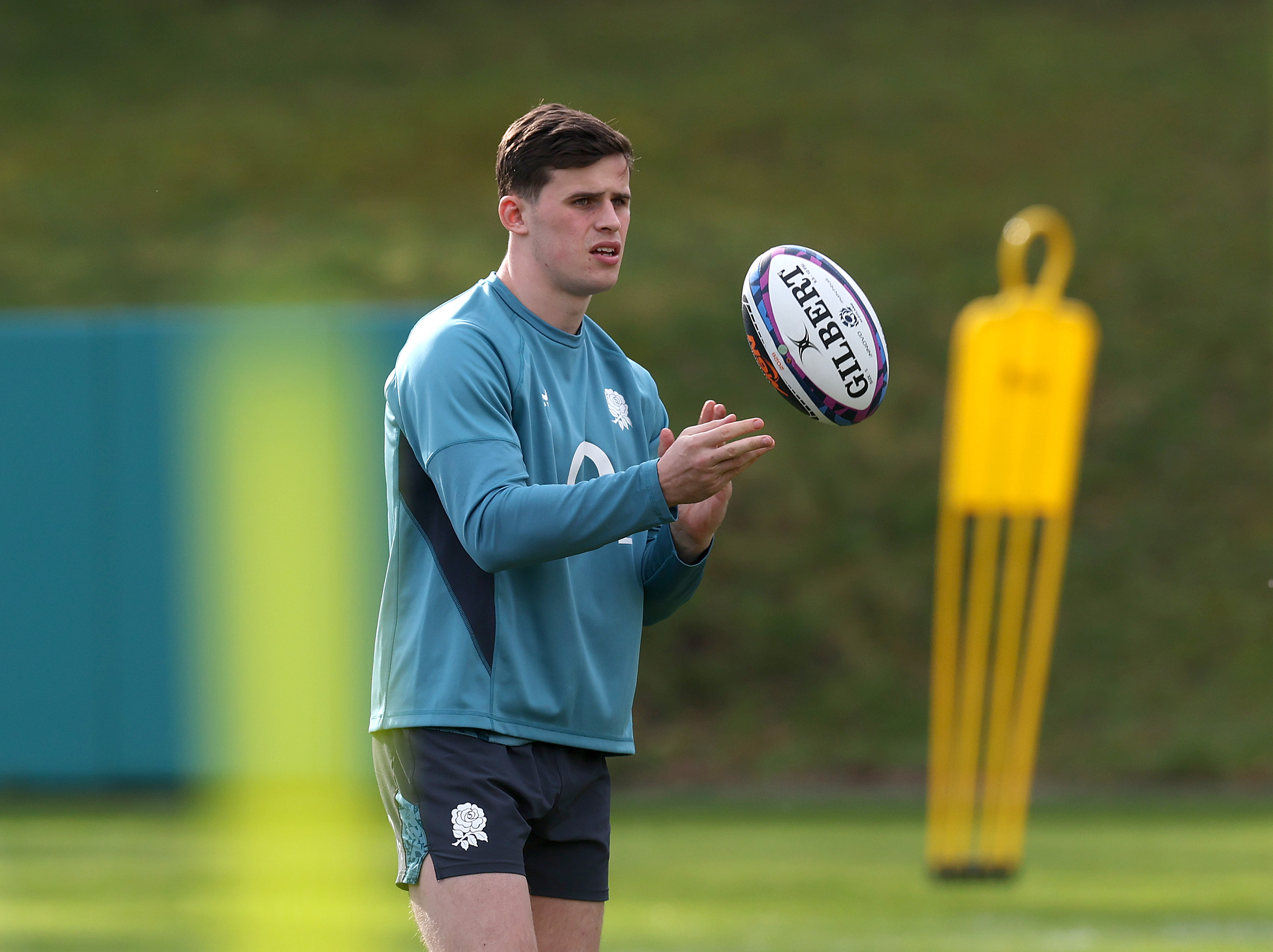 Seb Atkinson catching a rugby ball during an England training session.
