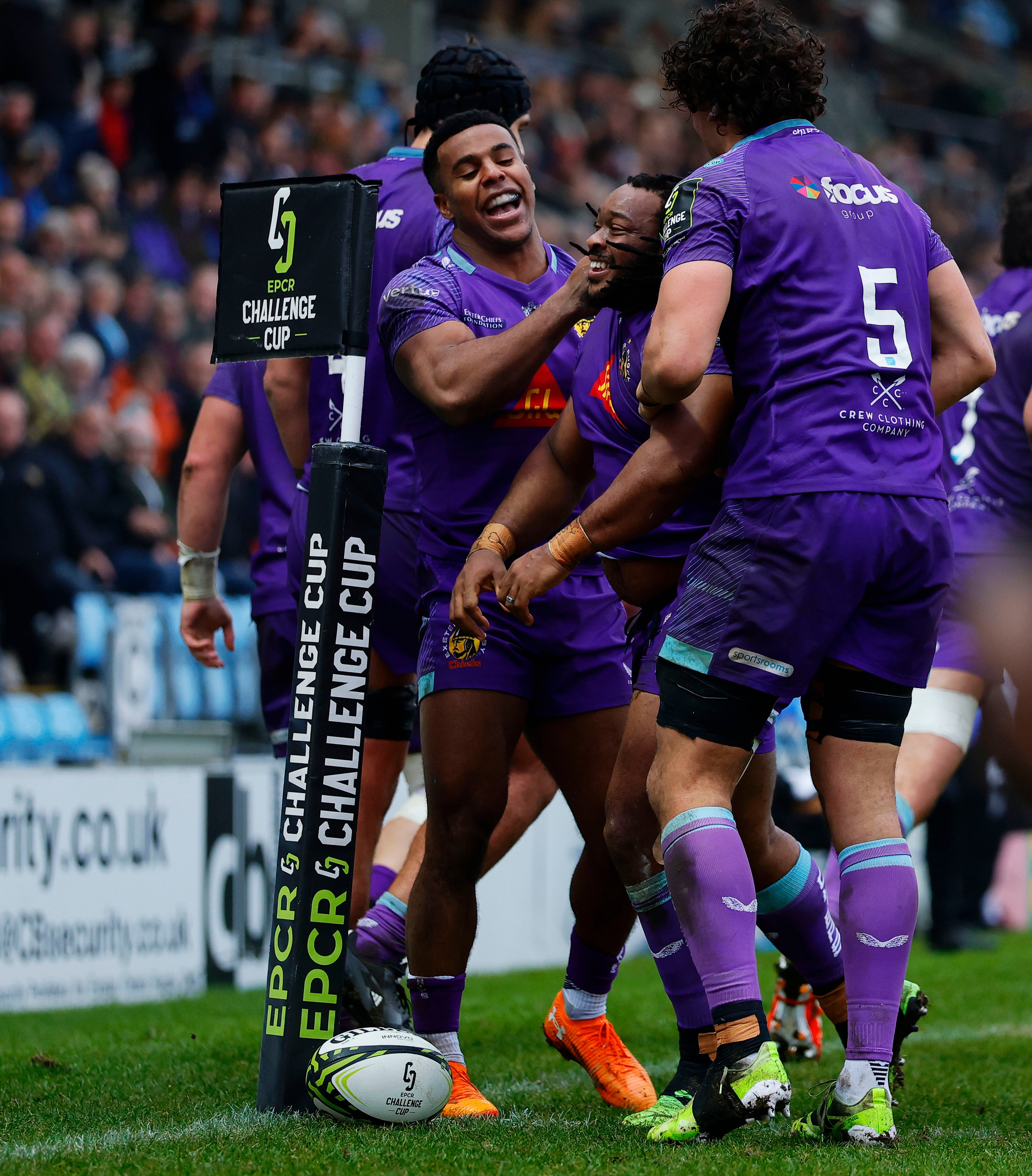 Joseph Dweba celebrating a try with teammates Immanuel Feyi-Waboso and Andrea Zambonin during a rugby match.