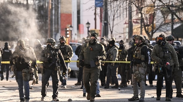 Federal agents stand near police tape in Minneapolis