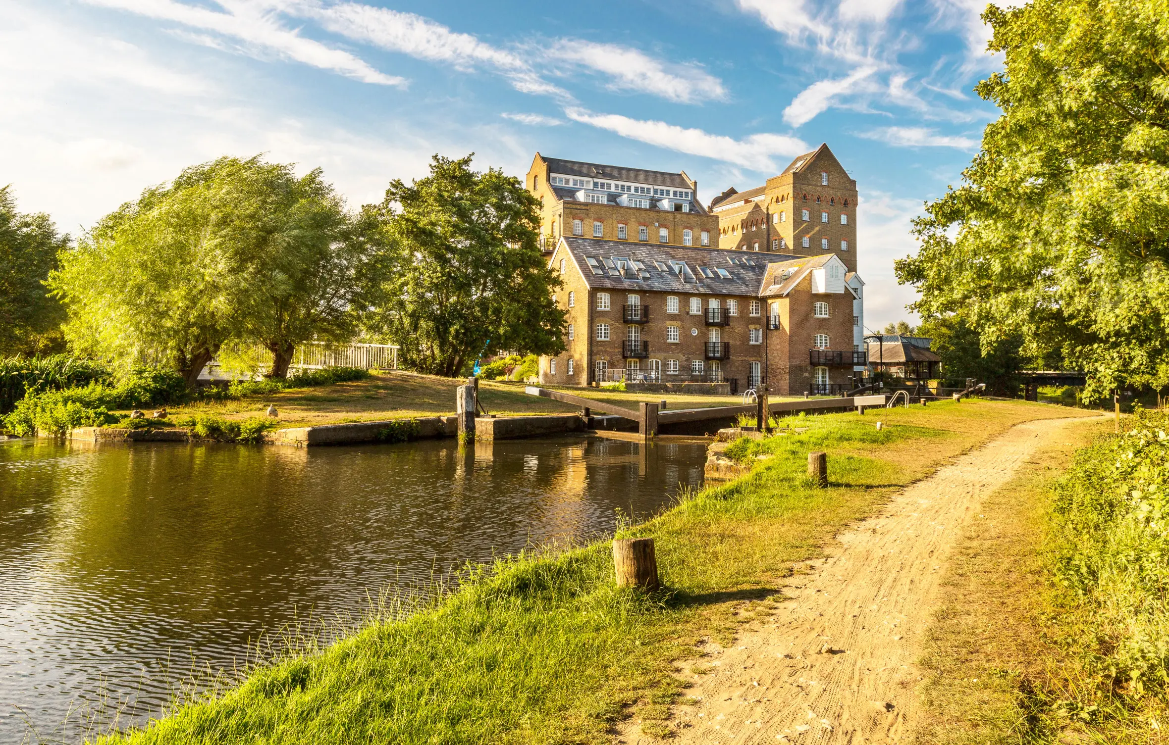 Coxes Mill and Lock on the River Wey Navigation in Addlestone, Surrey, England, UK.