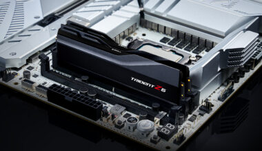 A close-up view of a G.Skill Trident Z5 RAM module installed on a high-end computer motherboard with metallic heatsinks.