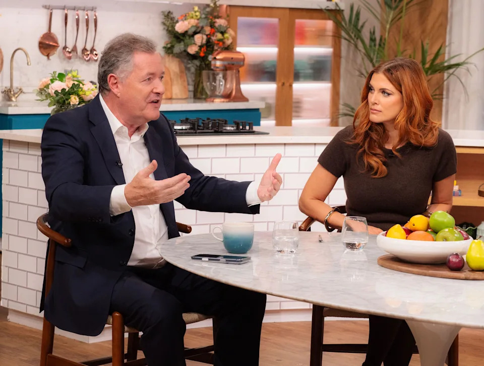 Shot of Piers Morgan and Ashley James sitting at a table on the set of This Morning.