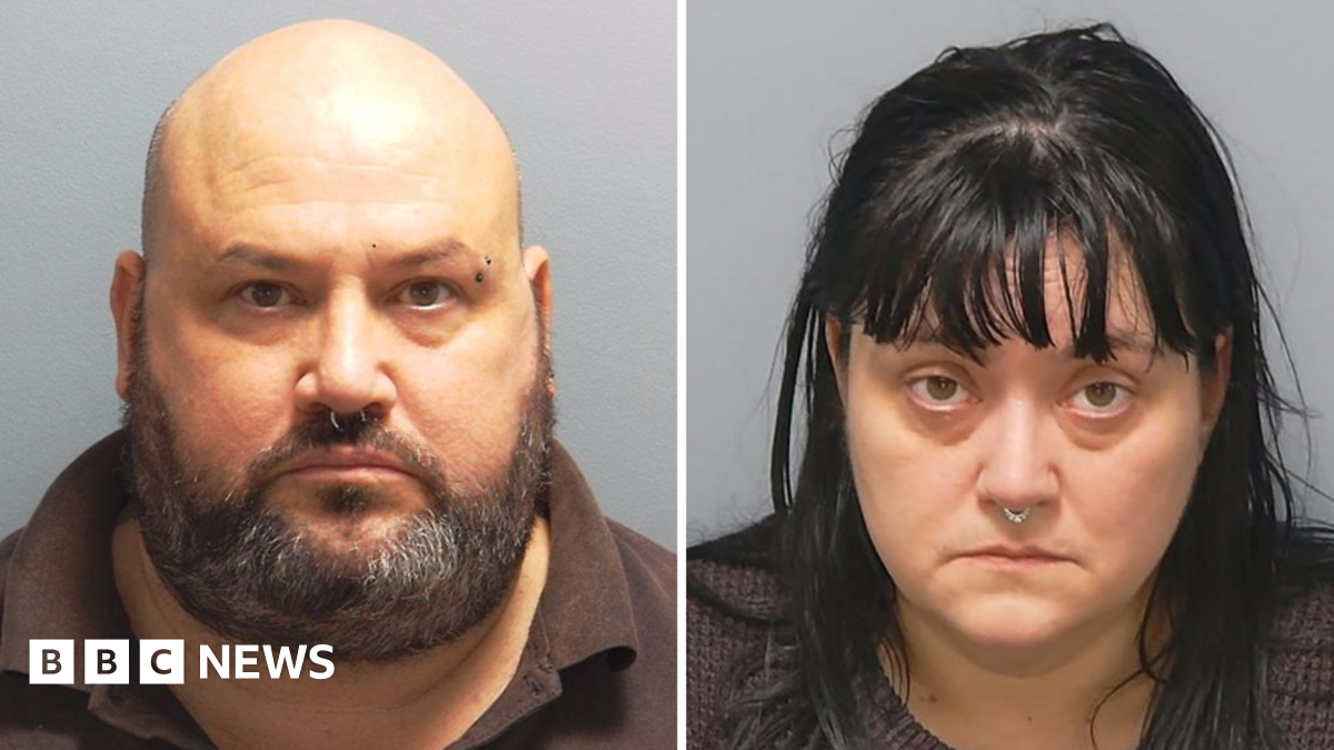 Custody photos of Richard Elkin and Hayley Bell. He is bald with a greying beard and a ring through his nose. She has black hair over her shoulders, a fringe and also has a ring through her nose.