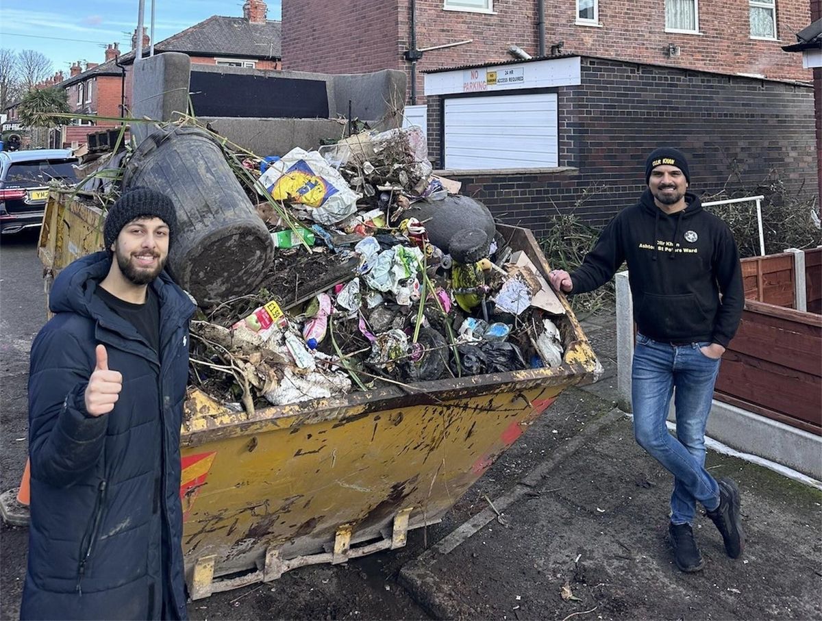 Ahmed Mehmood (left) and Coun Kaleel Khan next to a skip full of rubbish
